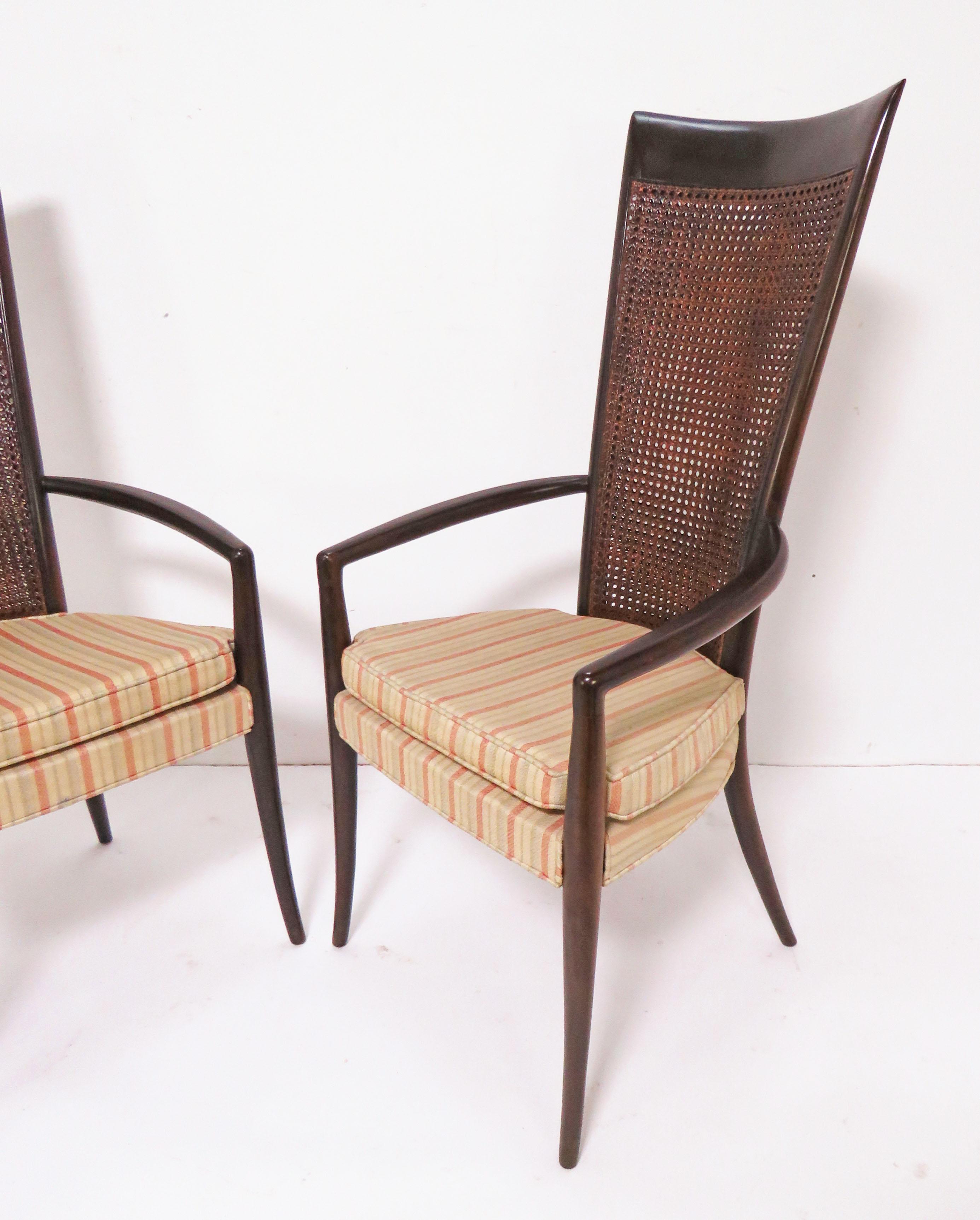 A pair of Italian high back armchairs with double paned woven cane back panels in the manner of Paolo Buffa.