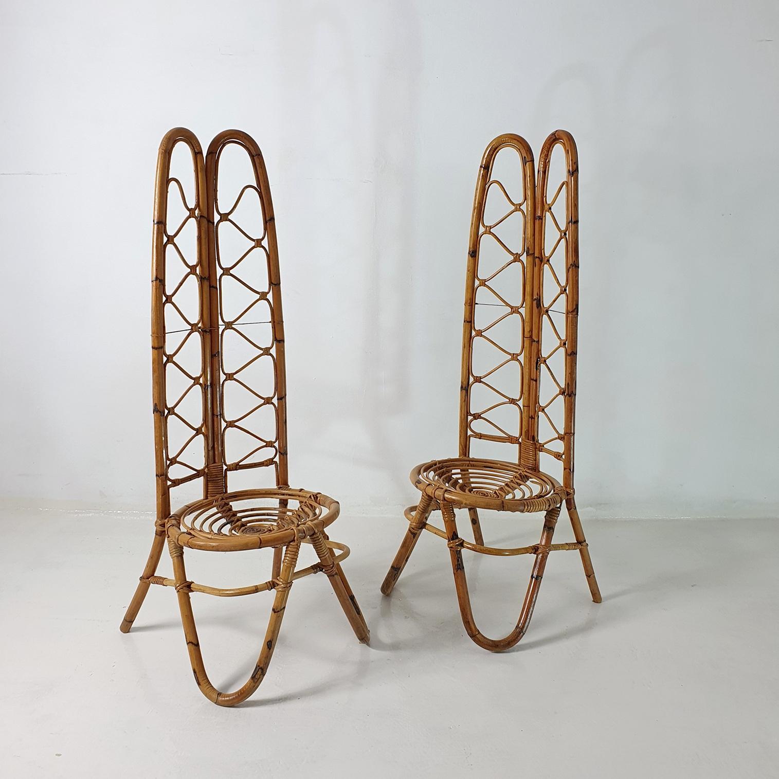 Midcentury pair of highbacked chairs in bamboo and rattan in the manner of manufacturer Bonacina from the 1950's. In good stable condition.