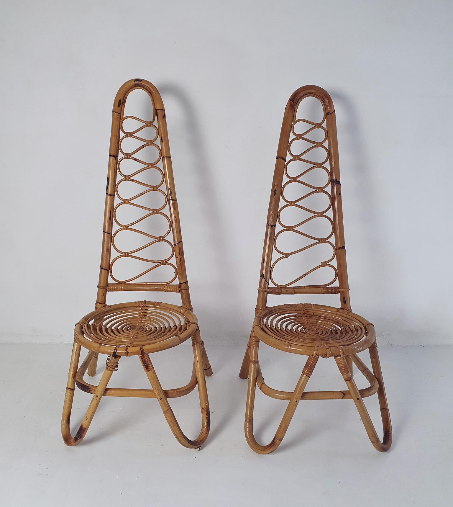 Midcentury pair of highbacked chairs in bamboo and rattan in the manner of manufacturer Bonacina from the 1950's. The diameter of the seat is 40 centimeters and the seat height is 35 centimeters. Would look nice matched with a small cushion as well.