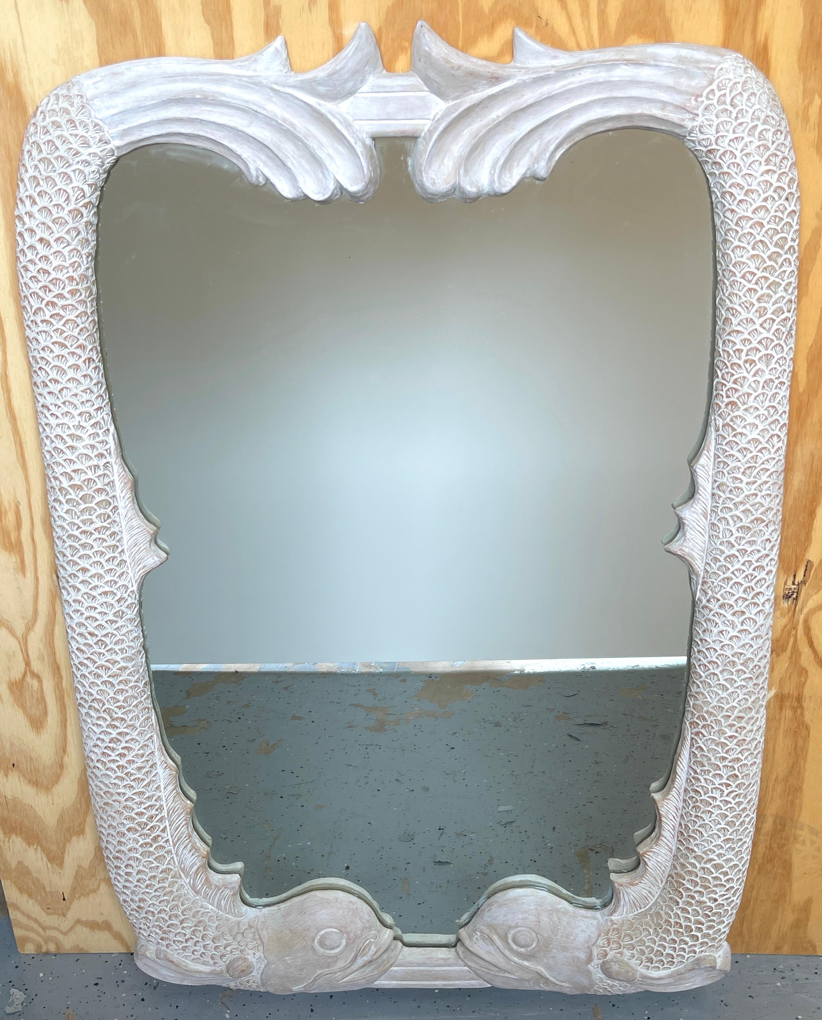 Pair of Italian Hollywood Regency carved whitewashed dolphin motif mirrors
Italy, circa 1960s

Each one of exceptional quality, with a center cartouche mirror flanked by twin carved wood and whitewashed figural dolphins. 

Overall