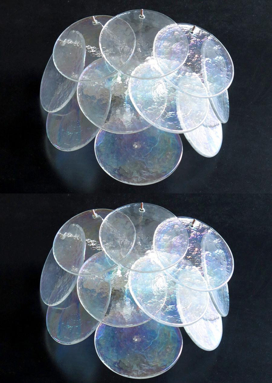 Spectacular pair sconces by Vistosi each made of 10 Murano discs iridescent color.
Wall lights have 10 glass for each,
iridescent color. The glasses are now unavailable, they have the particularity of reflecting a
multiplicity of colors, which