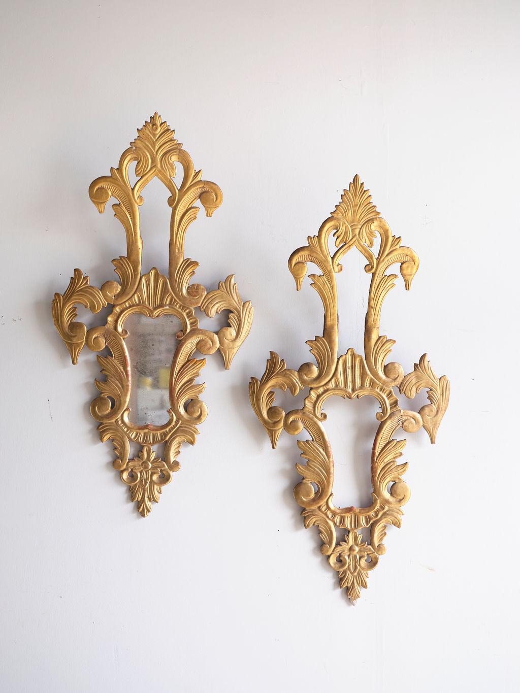 A pair of Louis XV carved gilt wood mirrored wall sconces with original antique mirrored glass. One of them is missing the mirrored glass; however, we will replace it with new antiqued mirror glass.