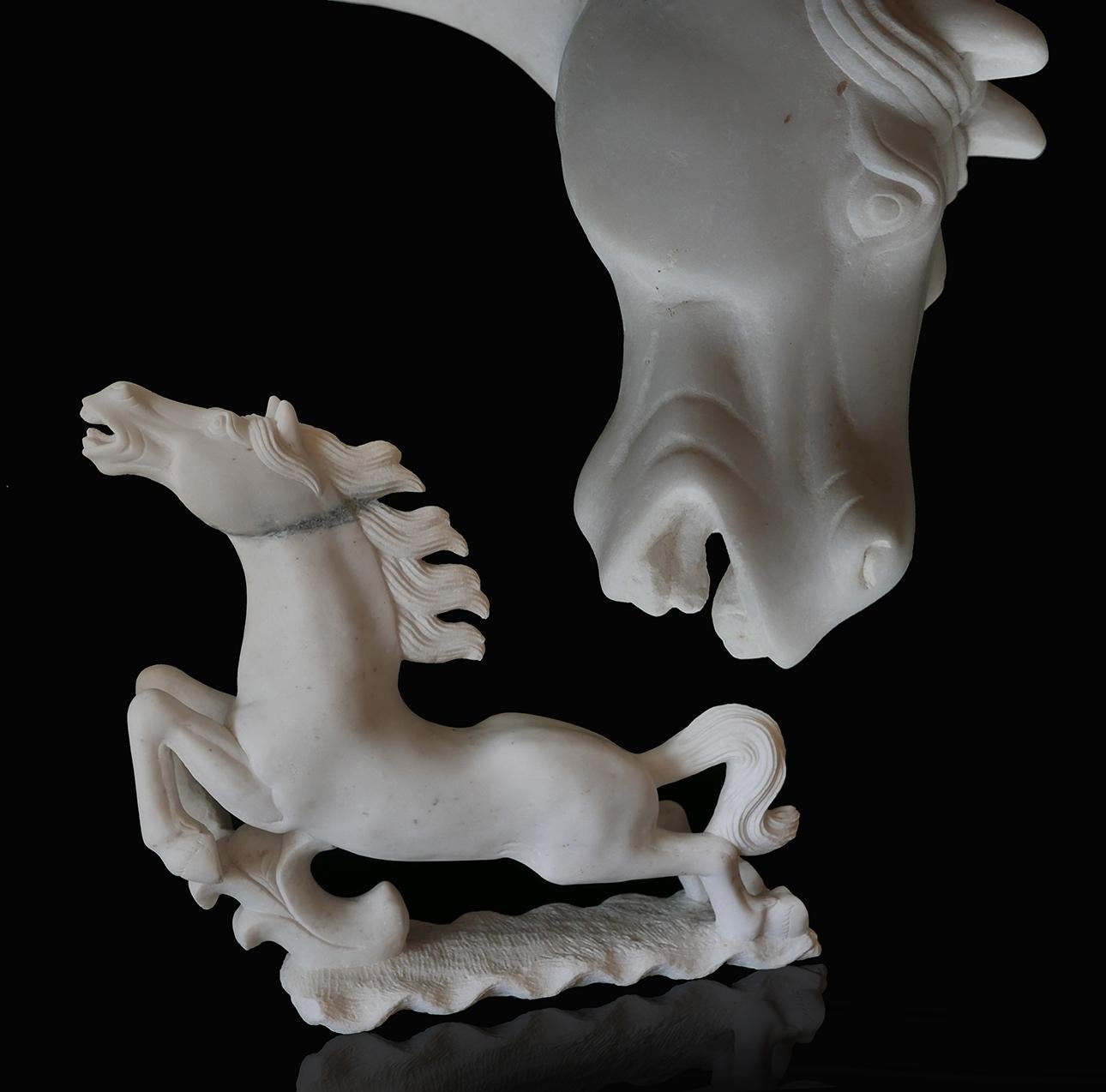Pair of Italian late Art Deco white Carrera marble figures of Stallions, 1940s. These are finely hand carved and are a real pair in that they face opposite directions.
 