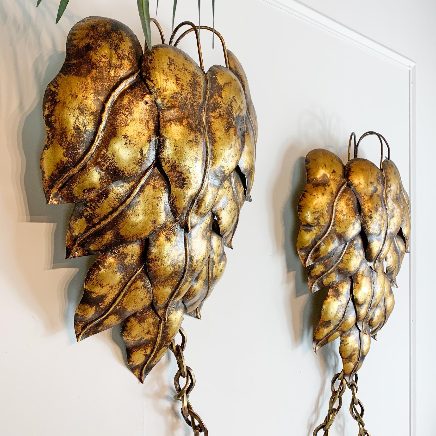 Incredible pair of 1950's Italian gilt swag wall lights, probably by Salvadori, each light in the form of a very large leaf with a single lamp holder behind each leaf, they are connected to each other with a heavy chain that extends downward for 1.6