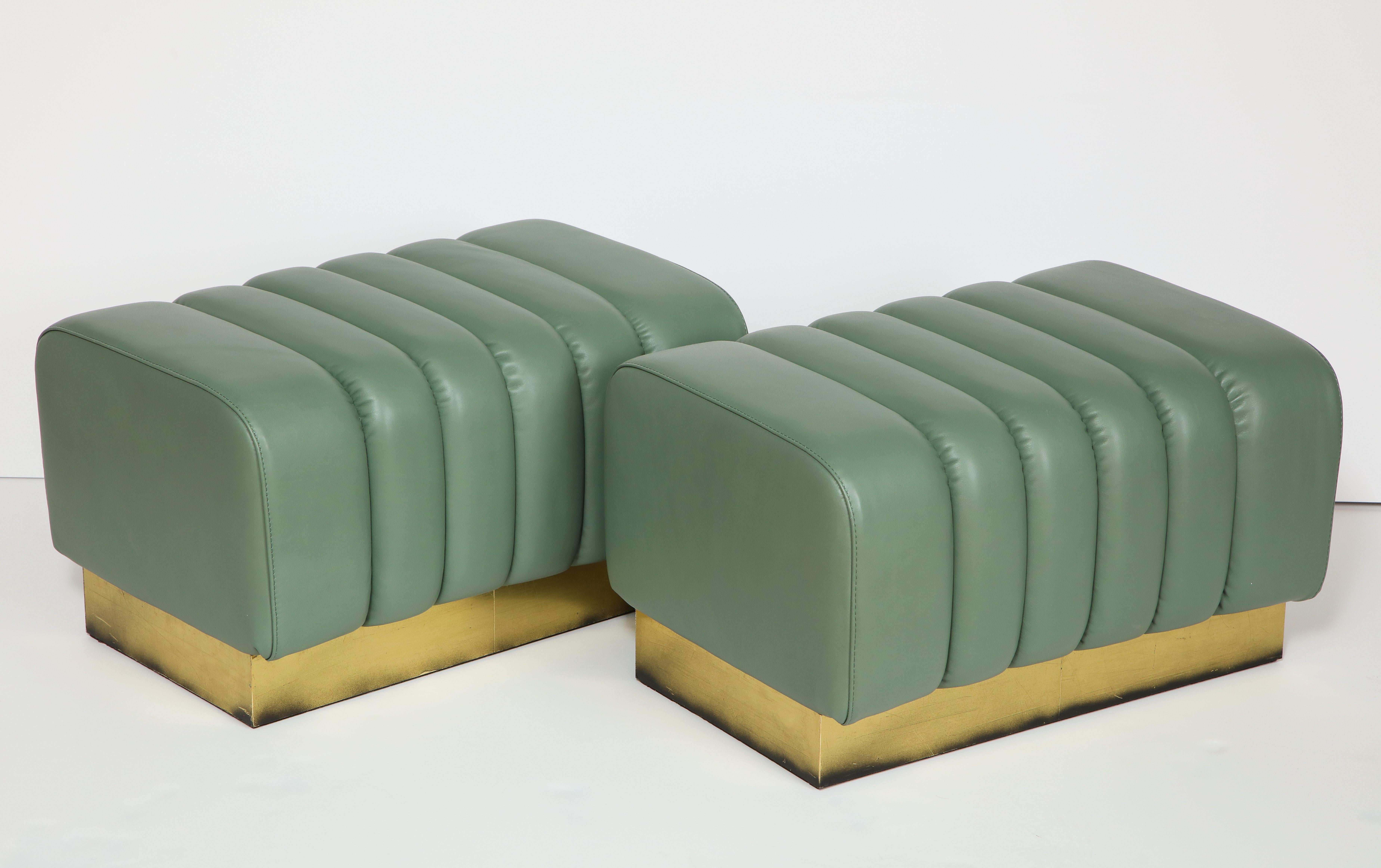 Exquisite in design and craftsmanship, this pair of leather benches were custom made for Karina Gentinetta in Florence, Italy. Soft, pliable Italian leather in a sage green color. Brass plynth base. These benches are available now at the 1stdibs