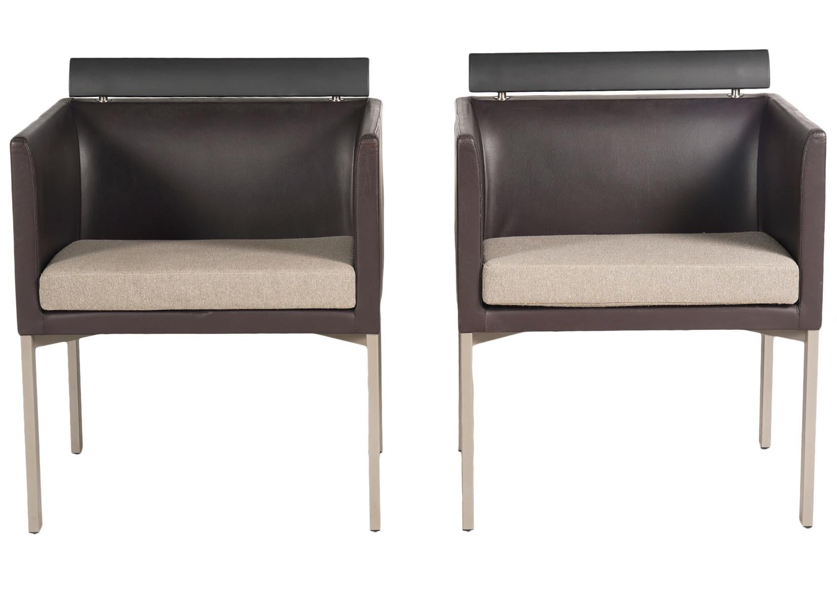 These modern Italian leather club chairs in the style of Antonio Citterio features a square design with sides and back of the same height. The backrests are mounted with shaped rubber rails as added back support. The flat seats are covered with gray