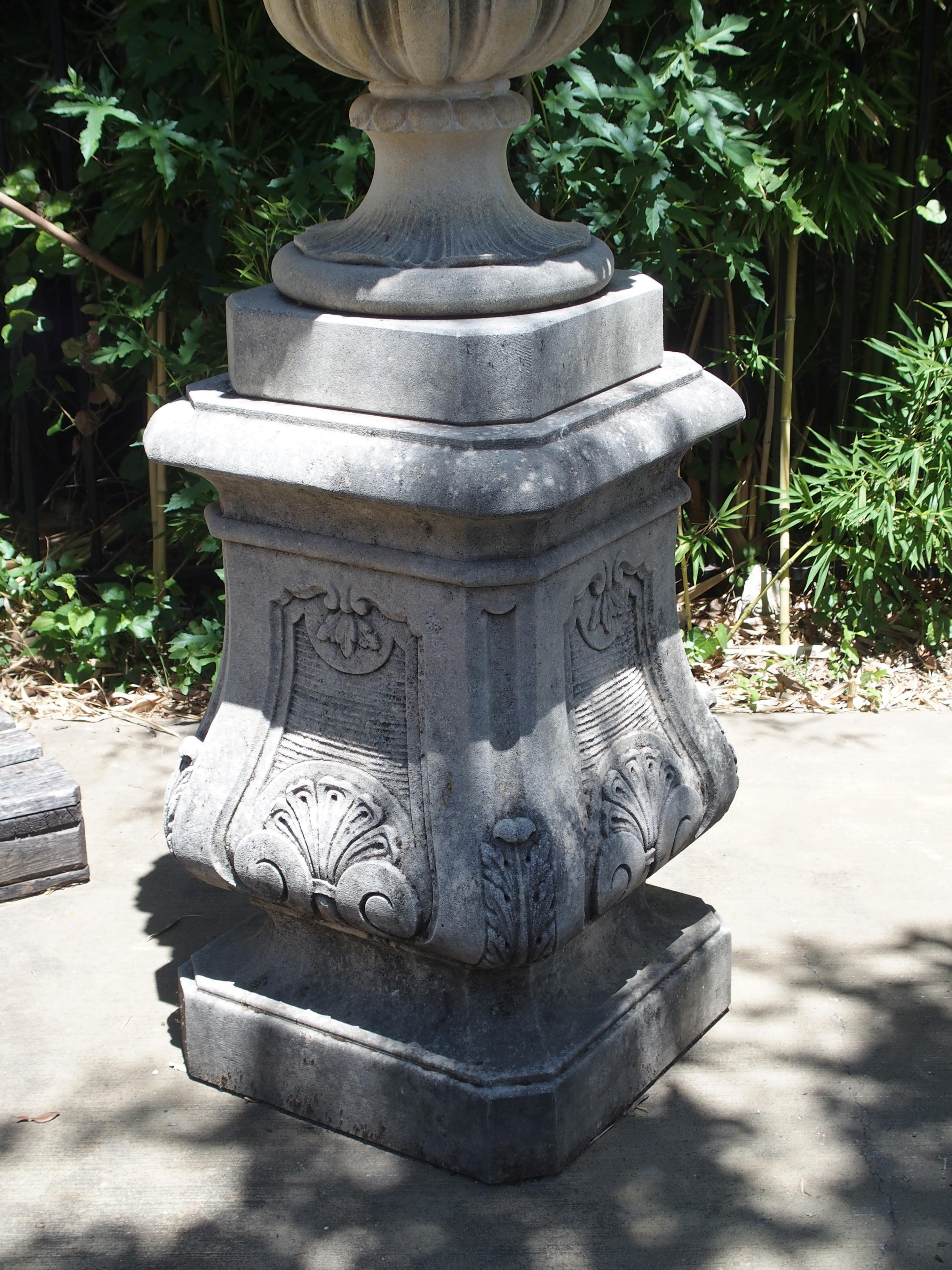 Hand-Carved Pair of Italian Limestone Urns with Fruit and Floral Bouquets on Pedestals