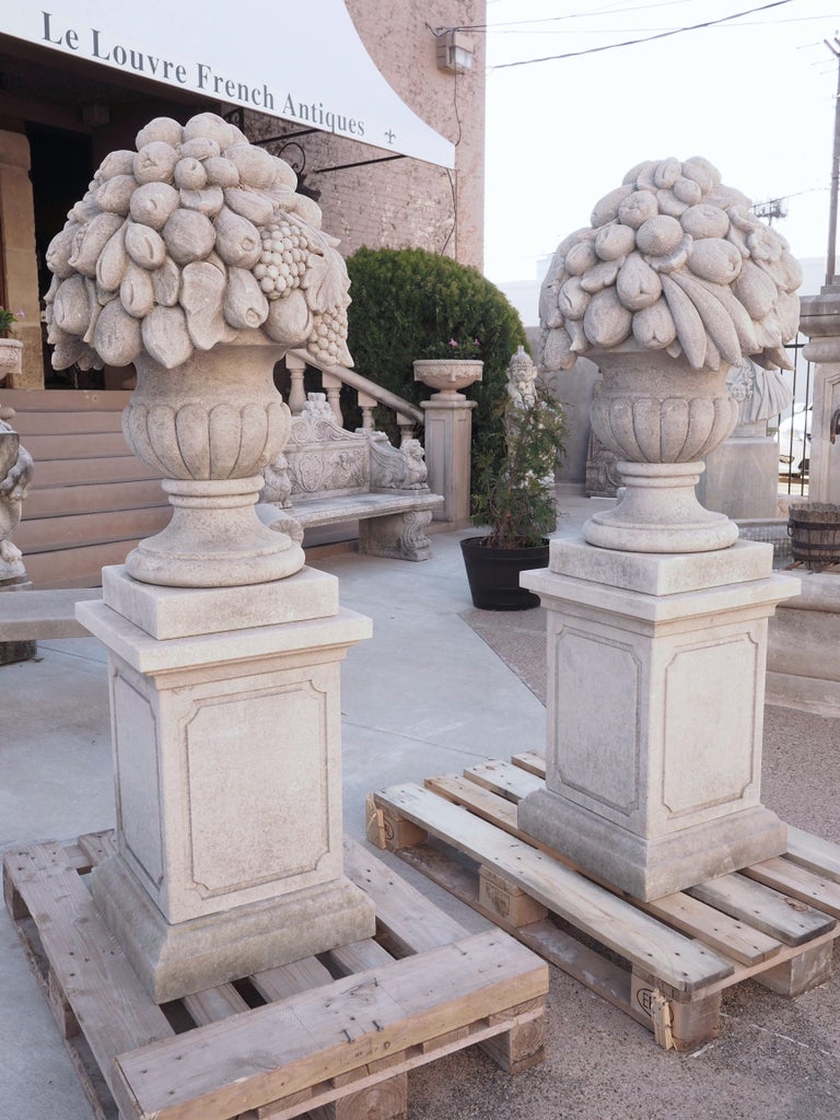 Pair of Italian Limestone Urns with Fruit and Floral Bouquets on