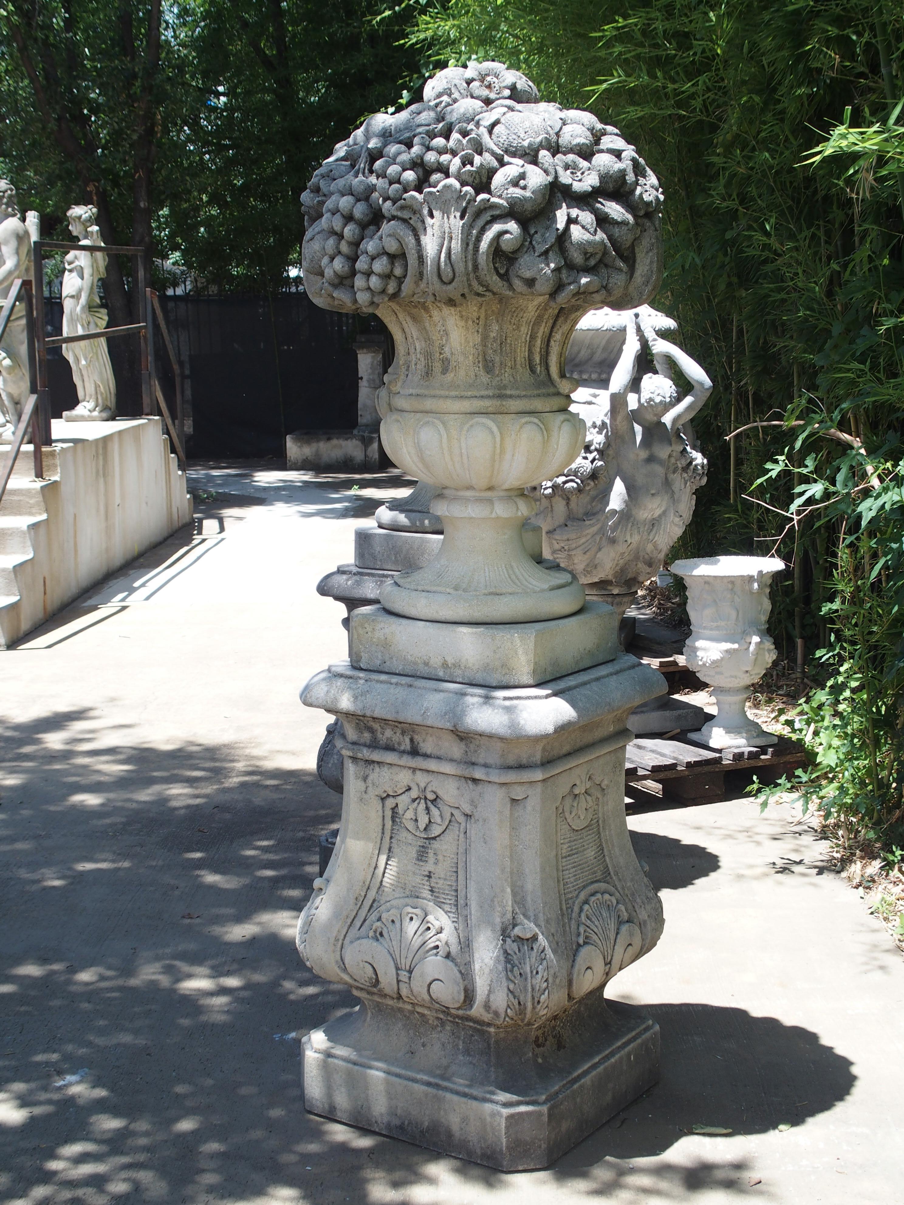 Contemporary Pair of Italian Limestone Urns with Fruit and Floral Bouquets on Pedestals
