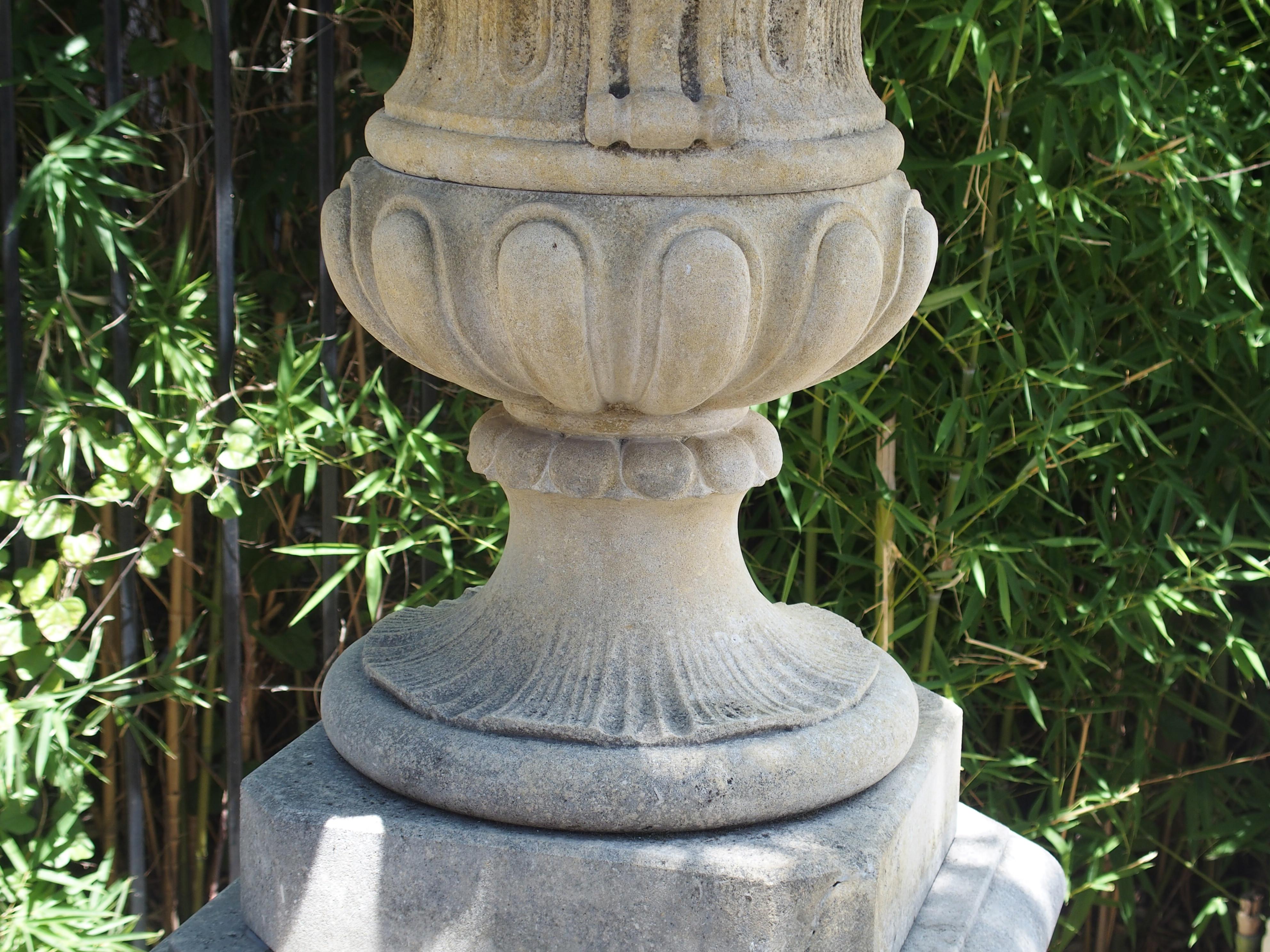 Pair of Italian Limestone Urns with Fruit and Floral Bouquets on Pedestals 1