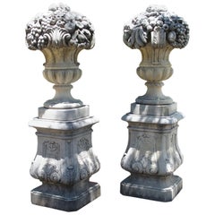 Pair of Italian Limestone Urns with Fruit and Floral Bouquets on Pedestals