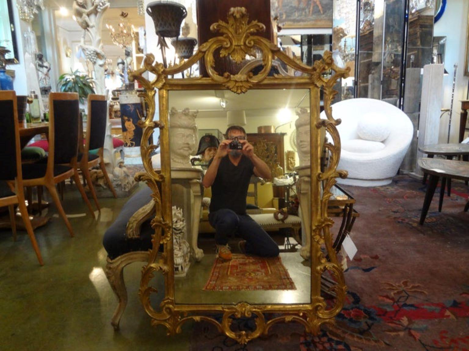 Stunning pair of Italian Louis XV style giltwood mirrors. This fabulous good sized pair of Italian gilt wood mirrors are an identical pair and in very good condition with great patina. The perfect pair to be placed above console tables, commodes,