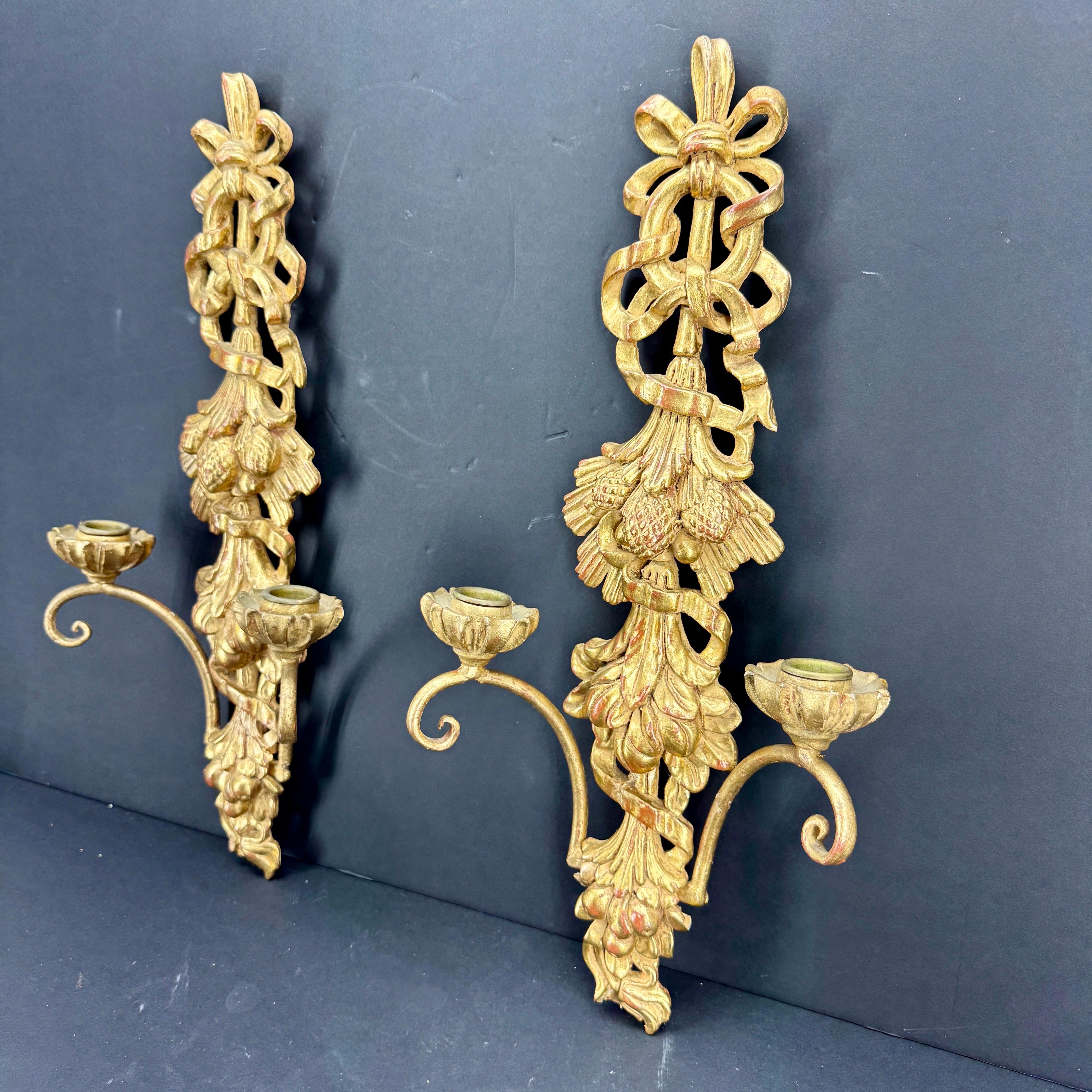 Giltwood Pair of Louis Seize Wall Candle Sconces, Italy 

Elegant wall candle sconces with beautiful detail throughout, including bows and ribbons as well as fruits. The hand-painted gold gilt finish on this pair has a very pleasing aged look. These