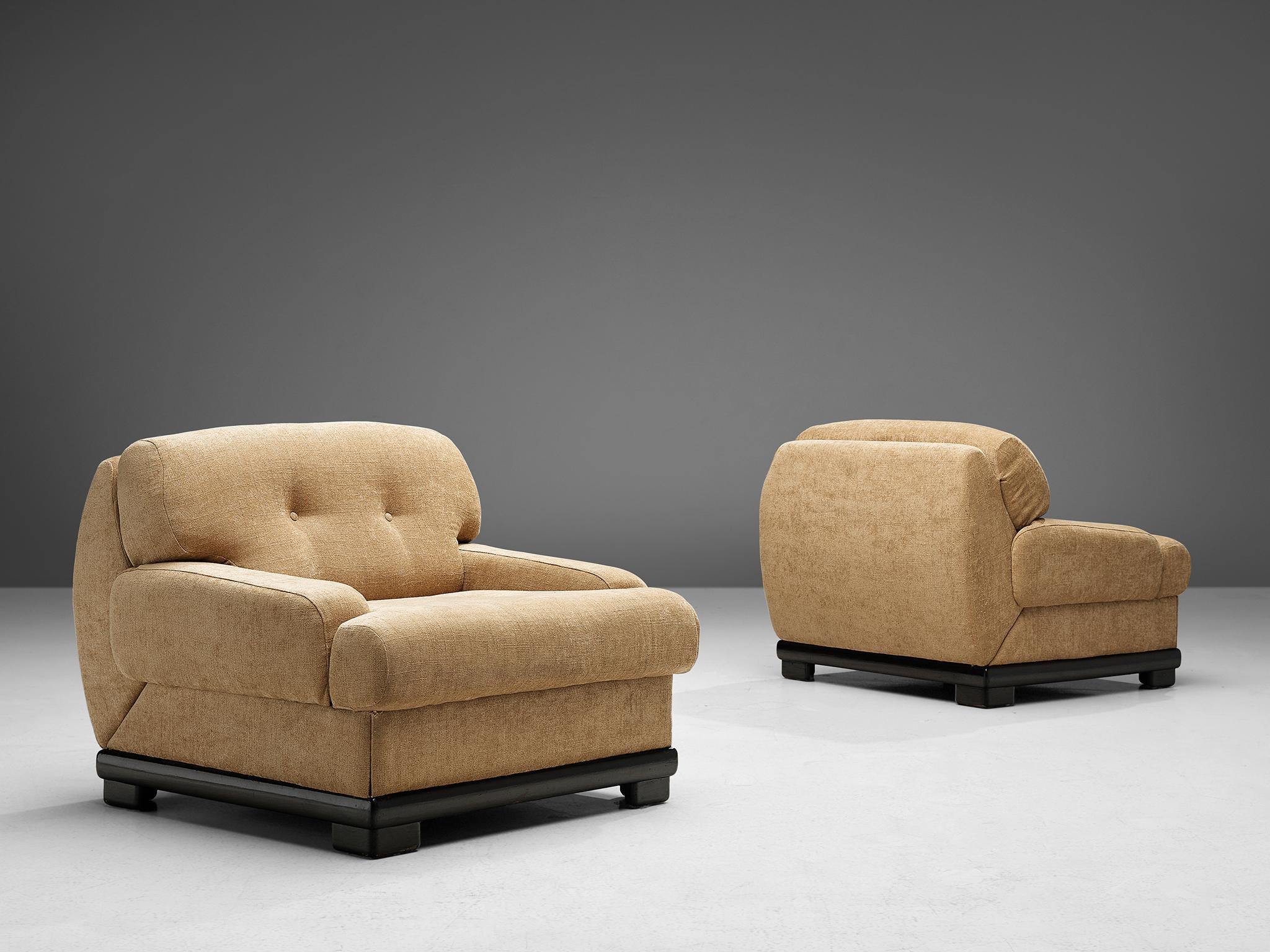 Set of two lounge chairs, fabric and lacquered wood, Italy, 1950s. 

Italian set of opulent armchairs with tufted backrests. These chairs are the pinnacle of lush and comfort thanks to the chunky shaped backrests and low armrests. The chairs feature