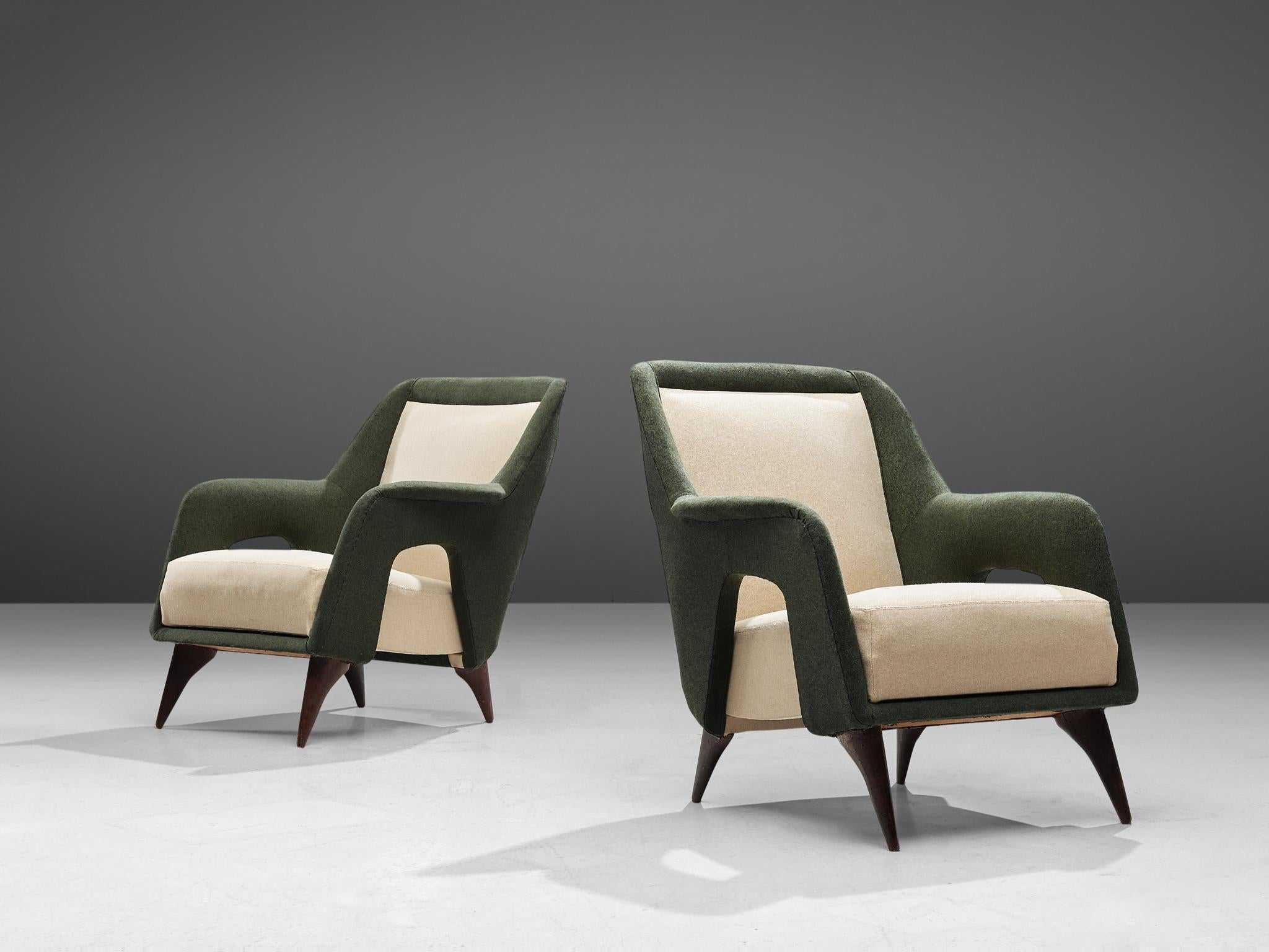 Pair of lounge chairs, fabric and walnut, Italy, 1960s

Gracious set of two Italian lounge chairs in a combination of forest green and off-white fabric. The backrests flow over into the armrests, which form a shell around the seat. The sides of