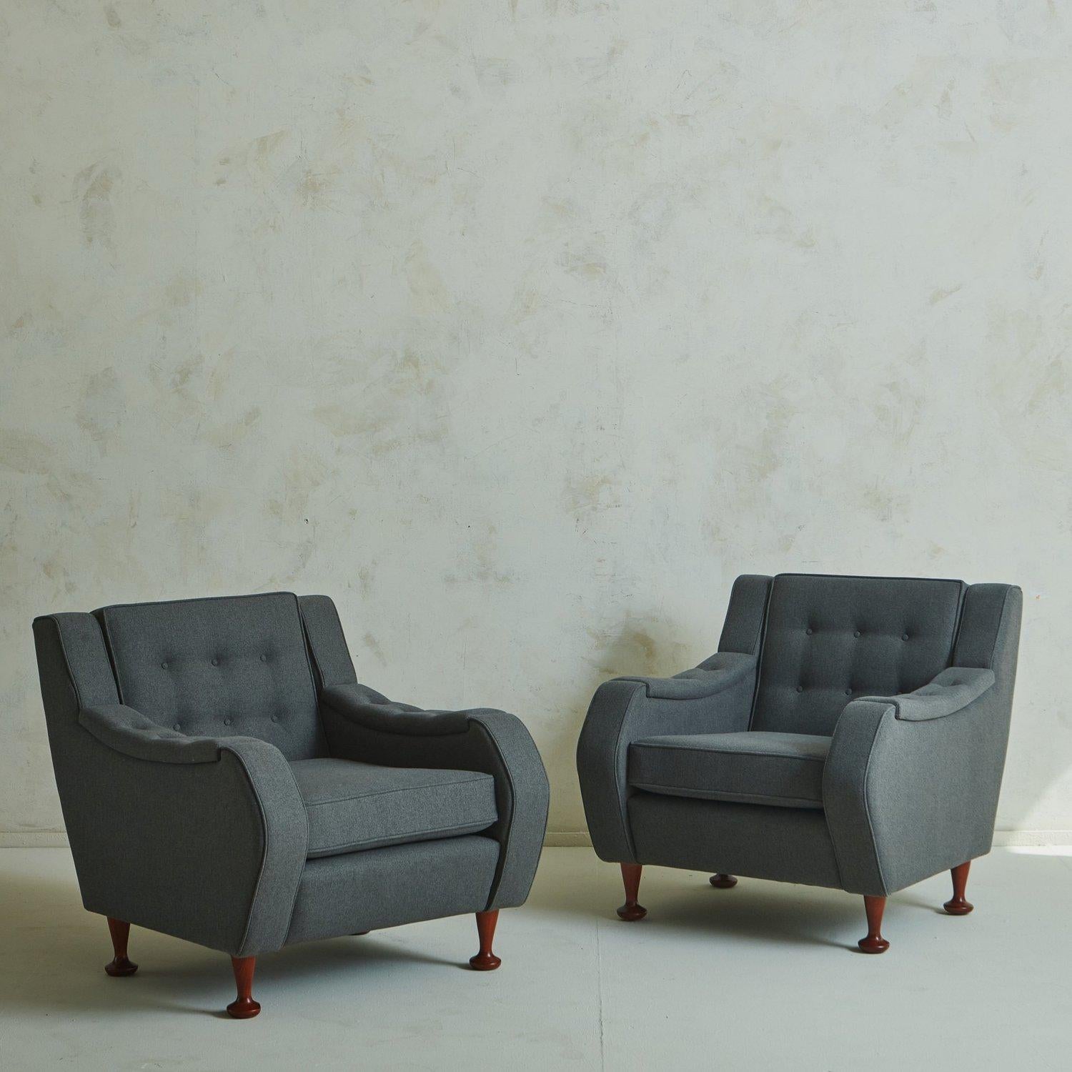A pair of 1970s Italian lounge chairs in the style of Angelo Mangiarotti. These chairs were freshly reupholstered in an elegant gray wool with single welt detailing. Six button tufts adorn the seat back, which compliment three button tufts on each