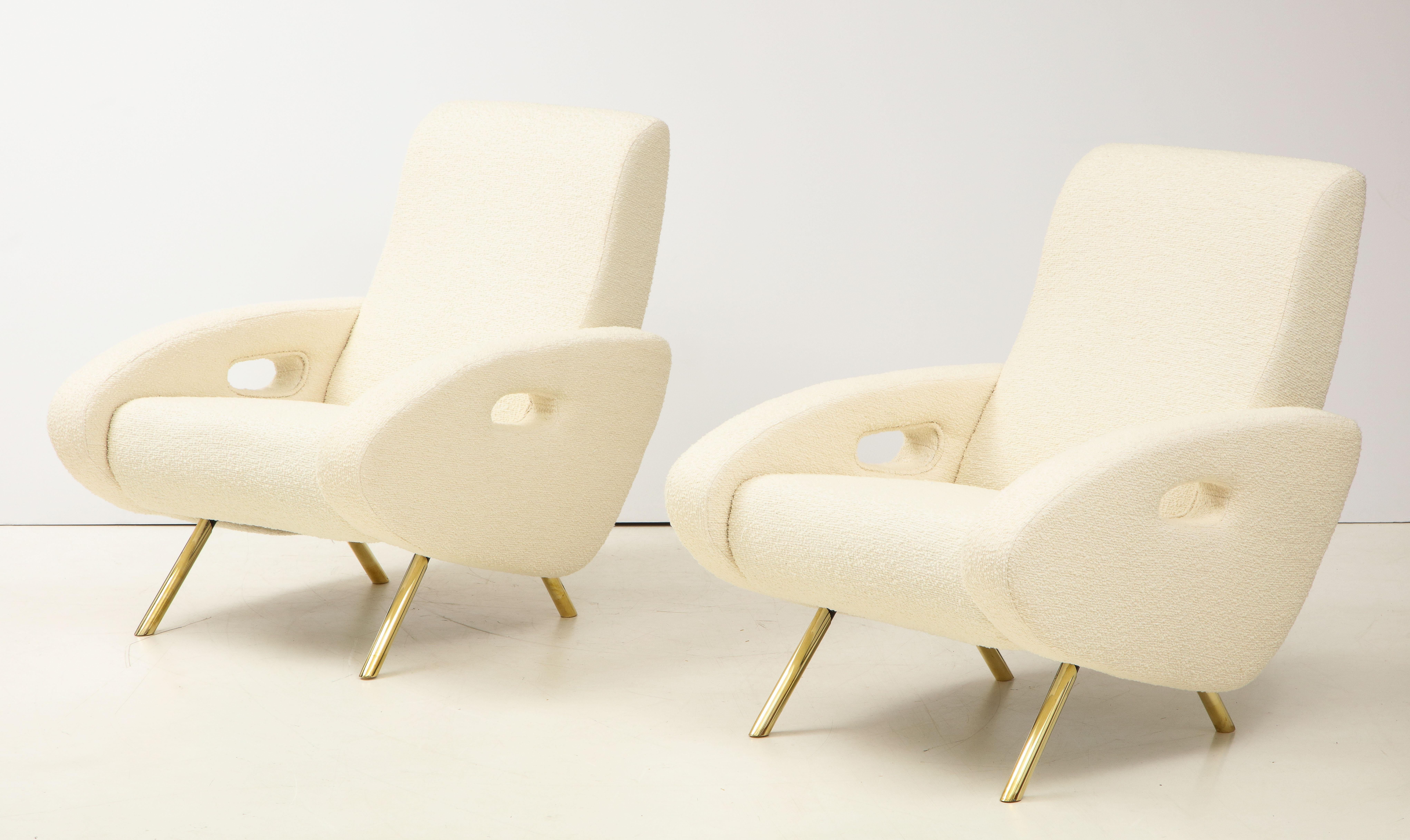 This pair of sculptural lounge chairs were newly handcrafted in Italy in the style of Francois Letourneau and reupholstered in a soft imported ivory bouclé fabric. Very comfortable and substantial with solid straight brass legs and shapely armrests.
