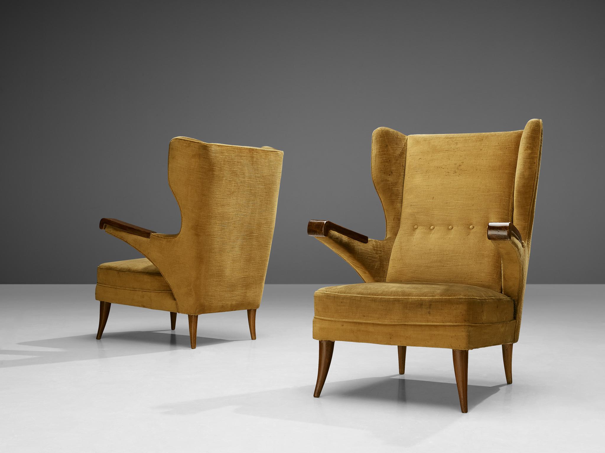 Pair of lounge chairs, velvet, stained beech, Italy, 1970s 

The construction and usefulness of this pair of lounge chairs is well thought out by the designer, resulting in this sophisticated shape. For instance, the armrests have been cut lose from
