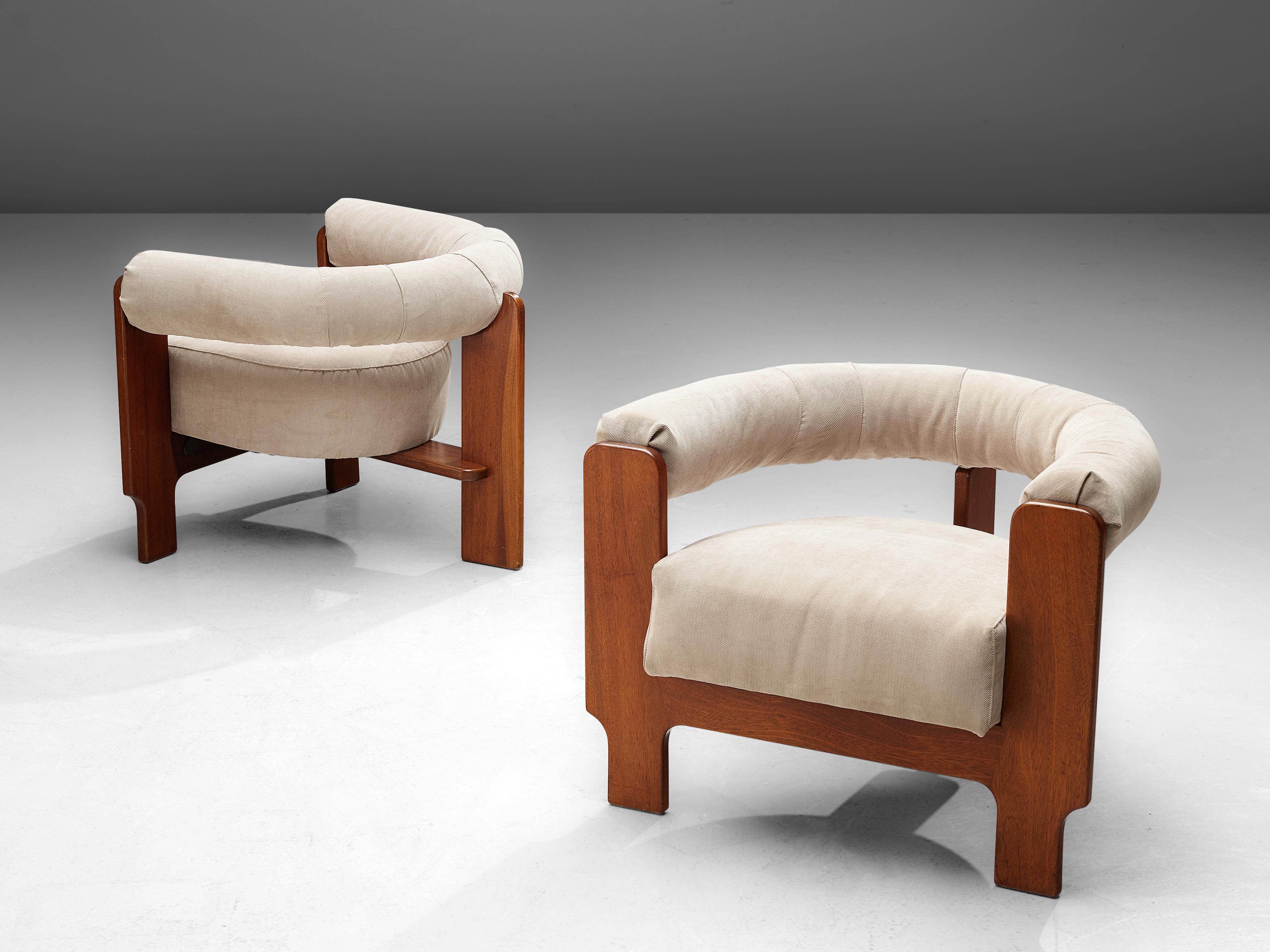 Set of two lounge chairs, mahogany and cream colored upholstery, Italy, 1960s.

Set of two Italian armchairs with mahogany frames. The wooden angular frame contrasts with the soft round shaped upholstered backrest and the comfortable seating pillow.