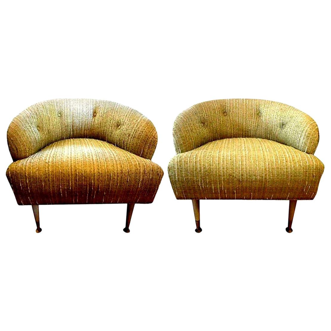 Chic and comfortable pair of Italian Gio Ponti inspired midcentury barrel back lounge chairs. These fabulous Italian lounge chairs, club chairs or side chairs have like beautiful neutral chenille like upholstery with tufted button backs. These