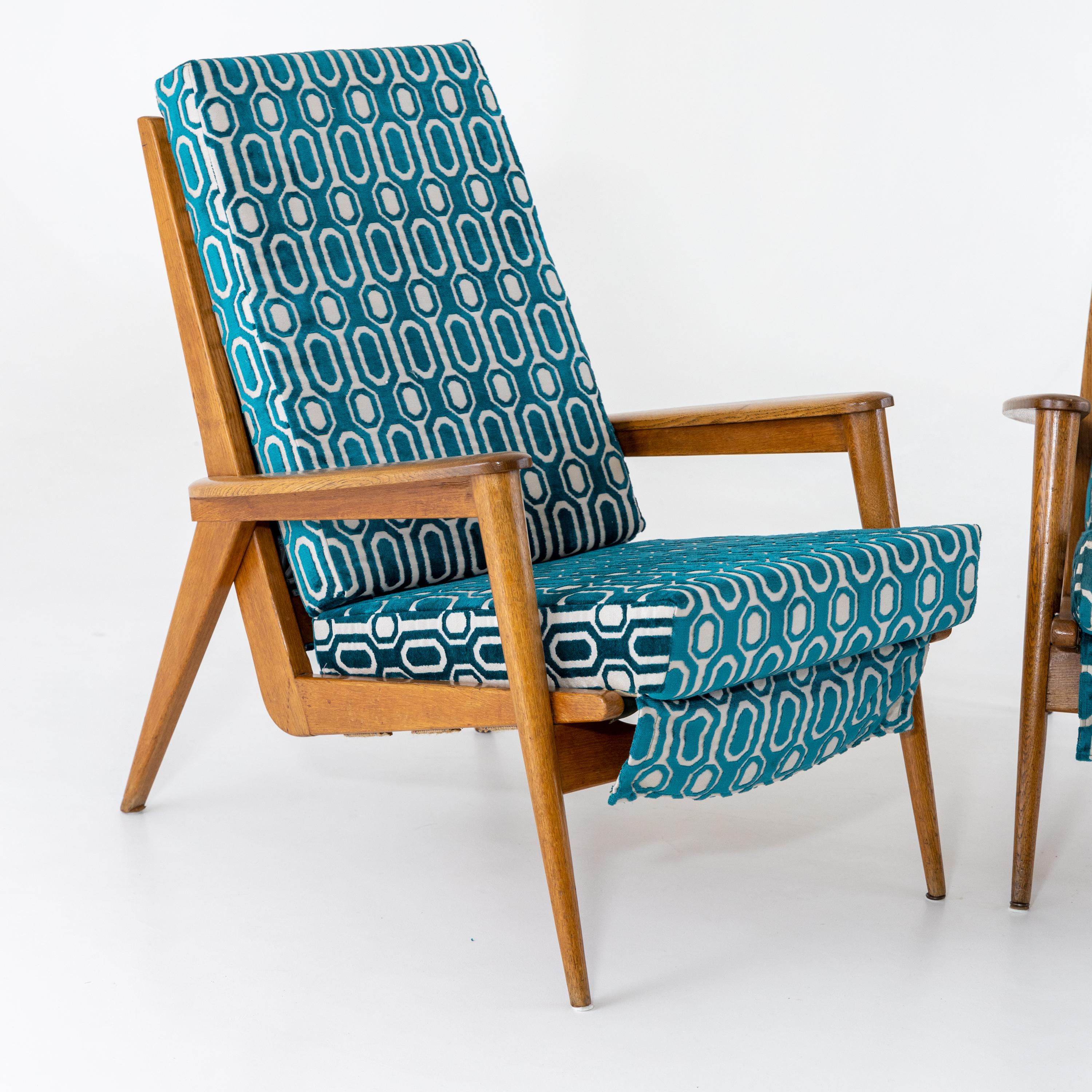 Pair of Italian armchairs on conical legs with upholstered seats and backs. The armchairs have been reupholstered in a blue and white fabric with a geometric pattern.