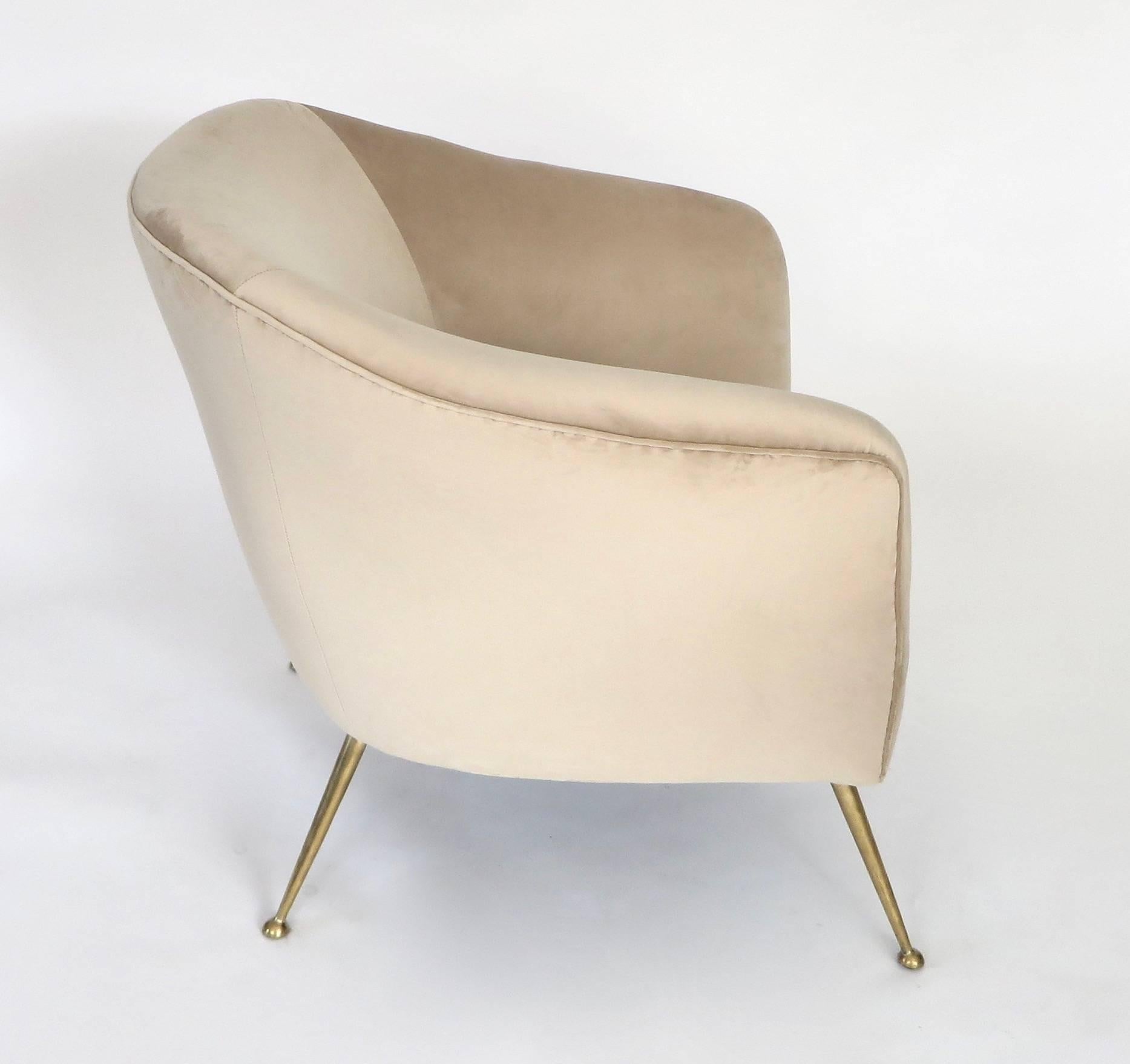 A pair of Isa Bergamo, Italian lounge chairs reupholstered in a pale champagne color silk velvet on polished brass legs. 
Overall size: 28