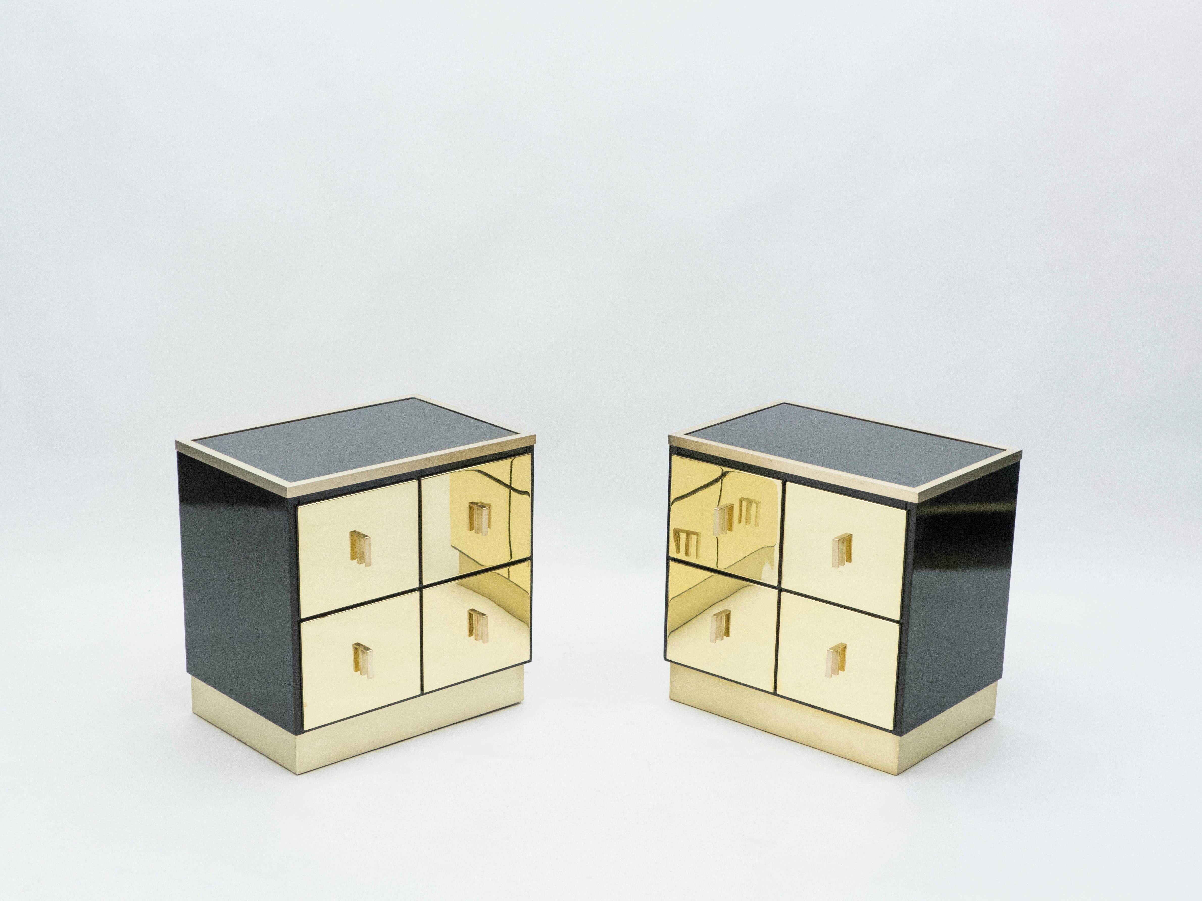 This rare pair of Italian midcentury two drawers black lacquered nightstands or end tables would be stunning in any room. Designed by Luciano Frigerio for Frigerio Di Desio in Italy in the early 1970s, the shiny black lacquer paired with the mix of