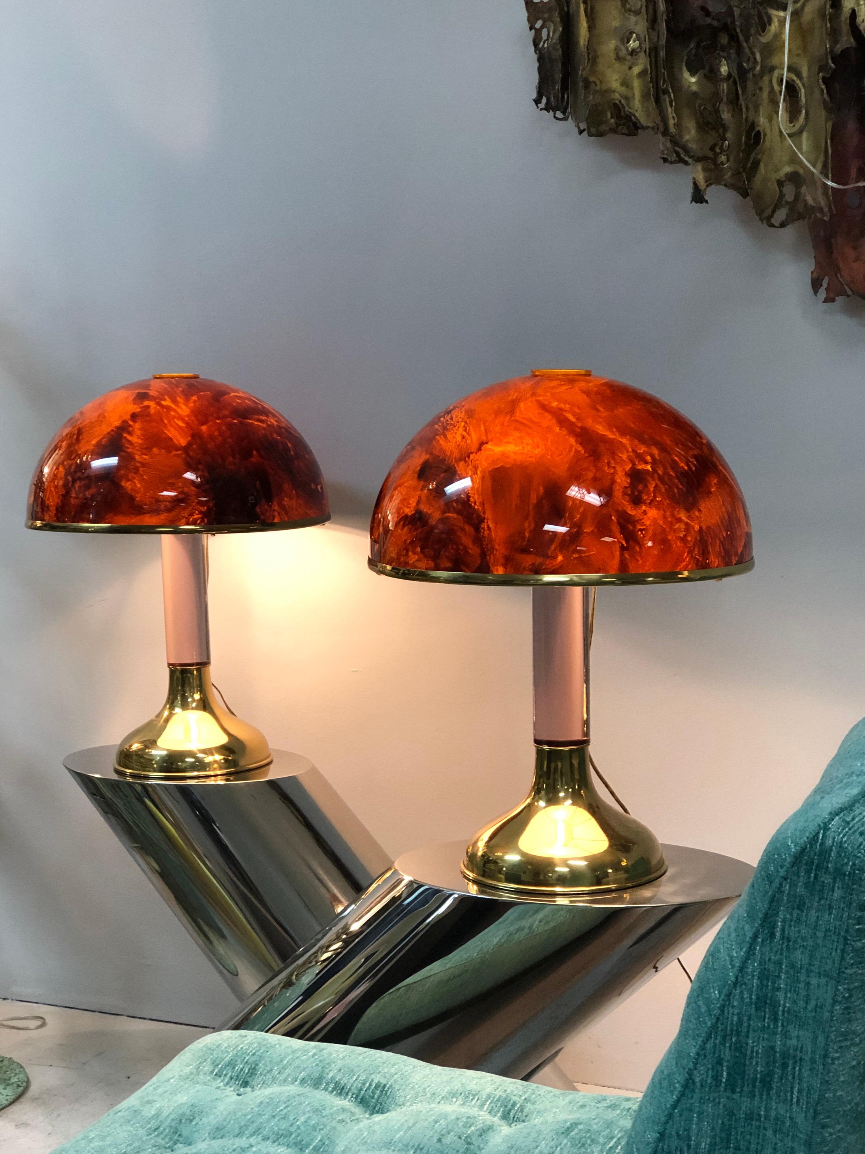 A pair of exquisite table lamps. Brass base with clear Lucite shaft and an acrylic dome shade done in faux tortoise design with brass trim. The look like pieces of jewelry in a room.