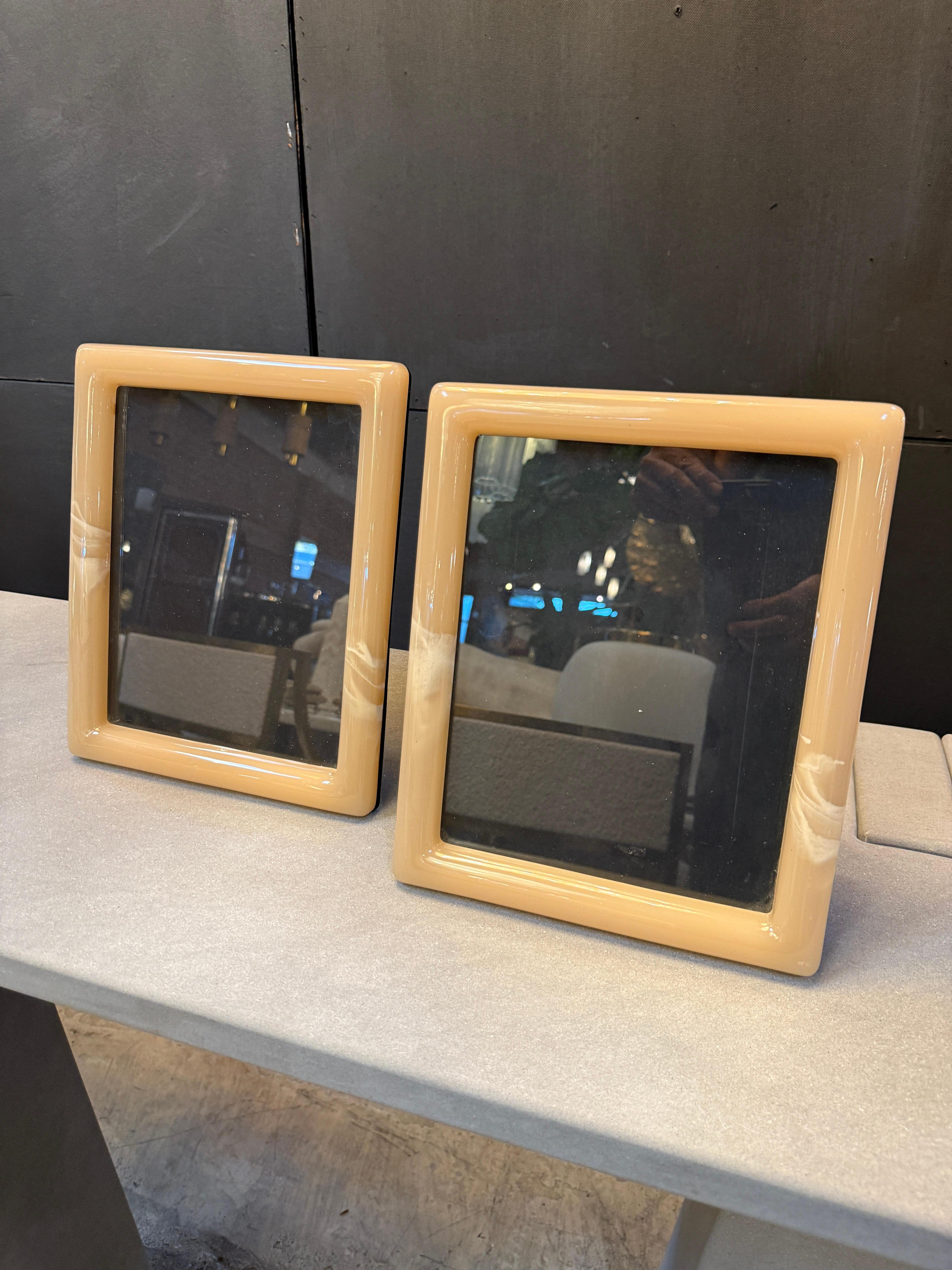 Material & Finish
Made from Lucite (a high-quality acrylic resin), known for its glass-like clarity and durability.

The surface has a smooth, glossy finish that gives the frames a sleek and modern look.

Lucite is often used in luxury Italian