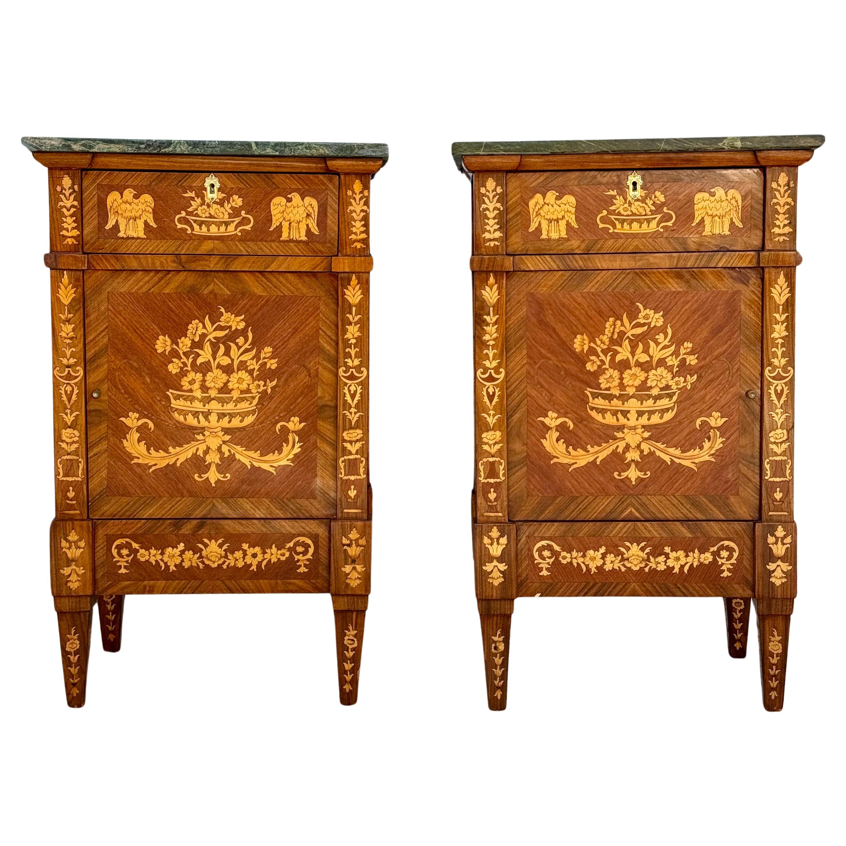 Pair of early 20th century Italian Maggiolini Style bedside chests with marble tops. Chests feature beautiful urns with eagle, floral and foliage designs. Each chest has a top drawer above a square door and stand on tall fluted legs. Elegant and