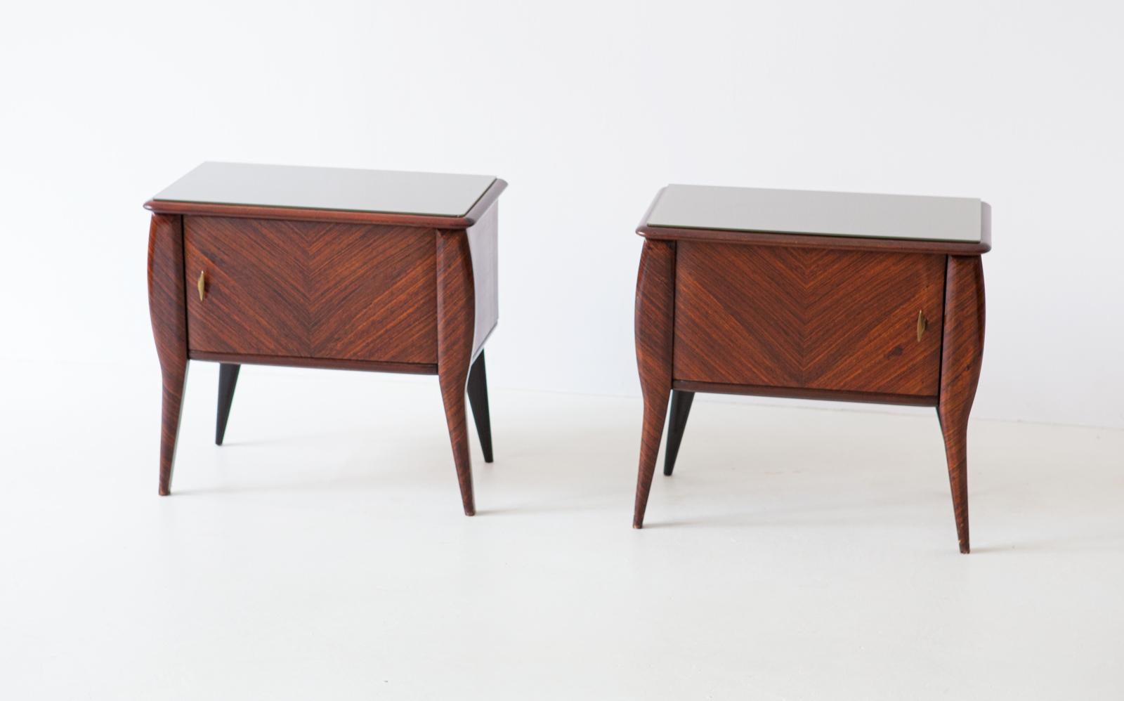 Set of two nightstands, manufactured in Italy in 1950s
These two side tables has made mahogany wood and glass top.

Very good shape, only light and pleasant signs of aging remain visible.
Brass handless

This is a Mid-Century Modern style