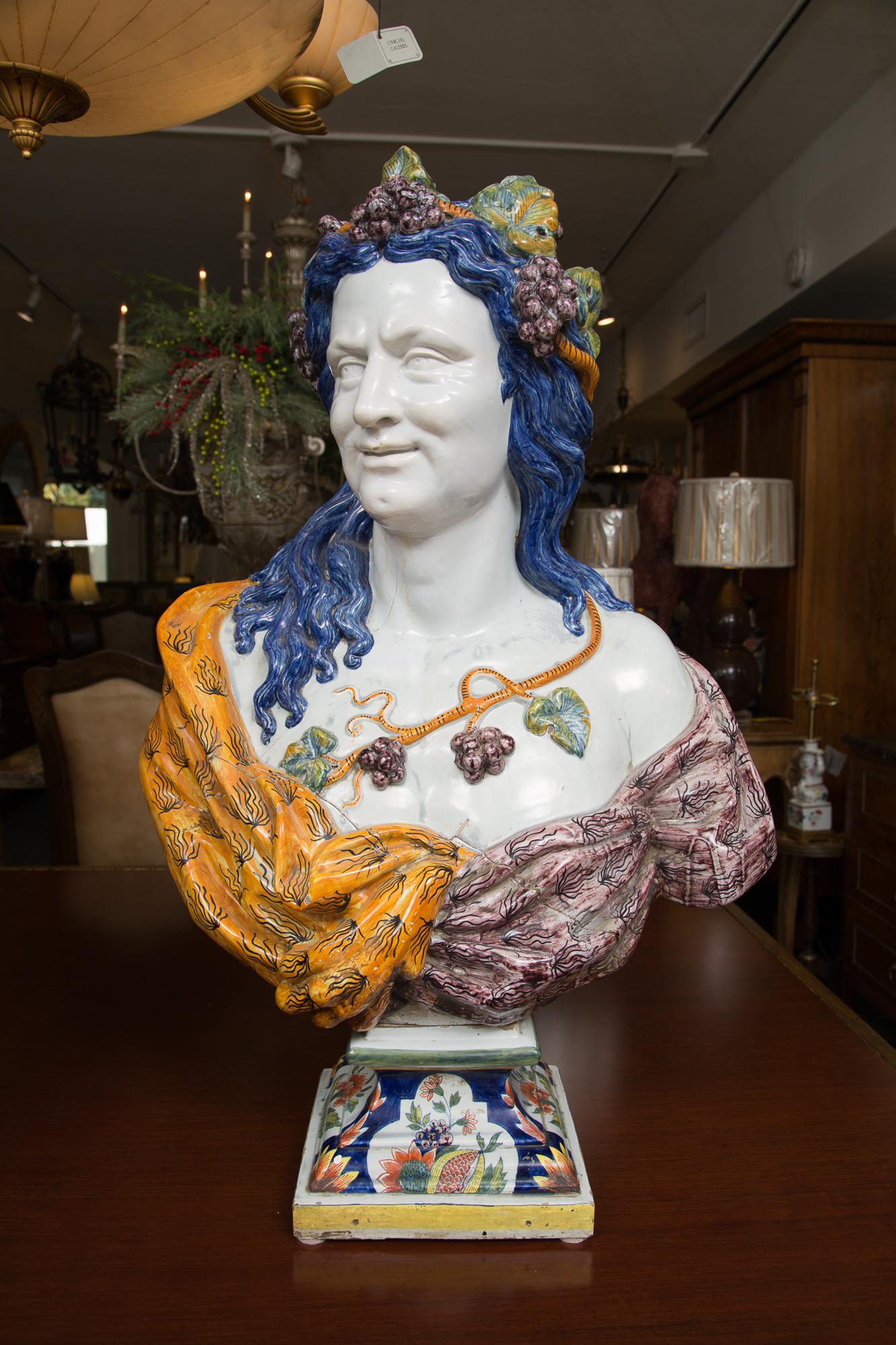 This is a magnificent pair of large Italian Majolica busts on decorative socles depicting a Renaissance couple. Both busts show exquisite sculptural detail expressed in a vibrant combination of sensuous hand painted colors under a glaze, 20th