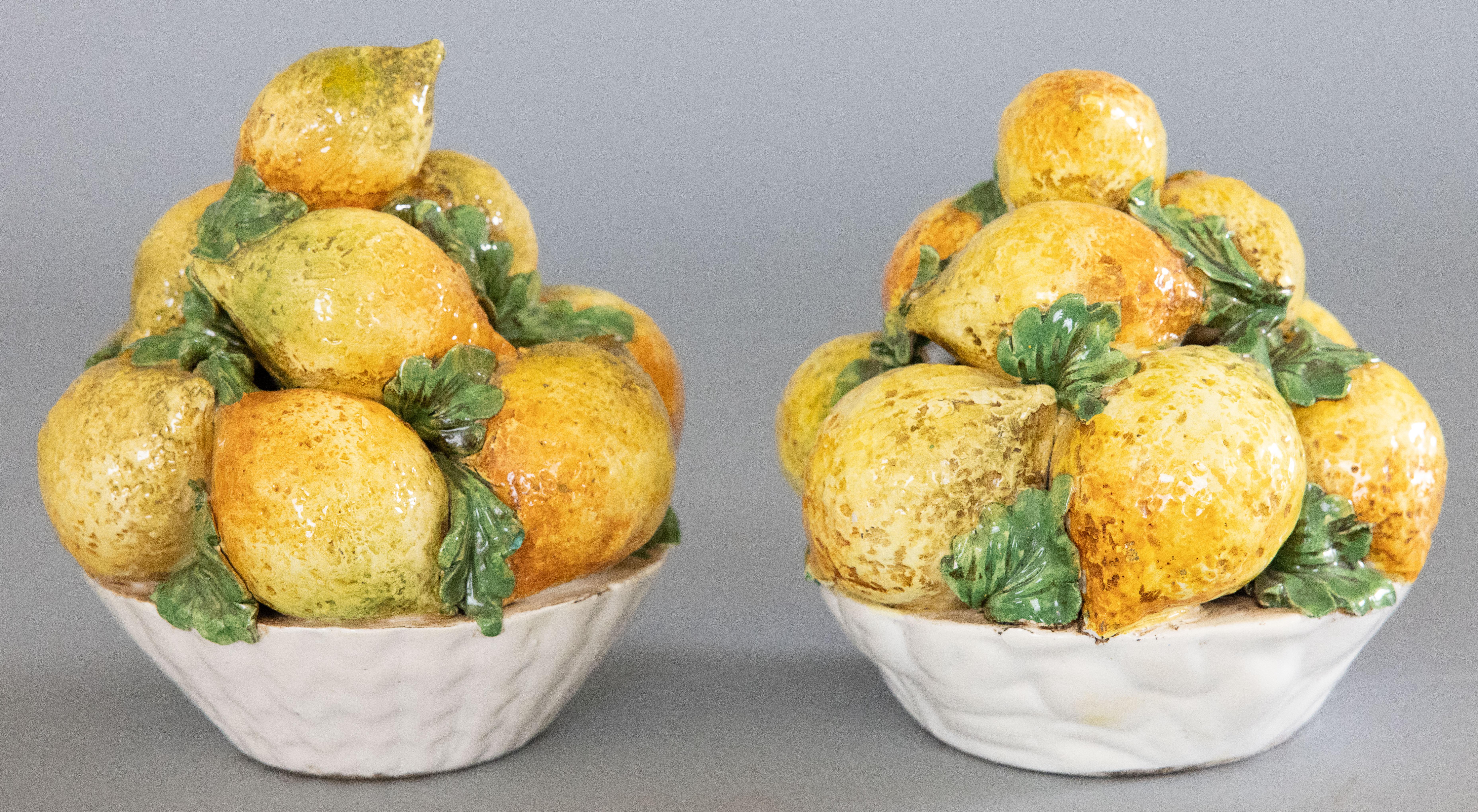 A lovely pair of vintage Italian majolica bowls of lemons centerpieces, circa 1950. Freshen up your kitchen or breakfast room with these gorgeous hand painted arrangements of lemons accented by vibrant green leaves in white latticework