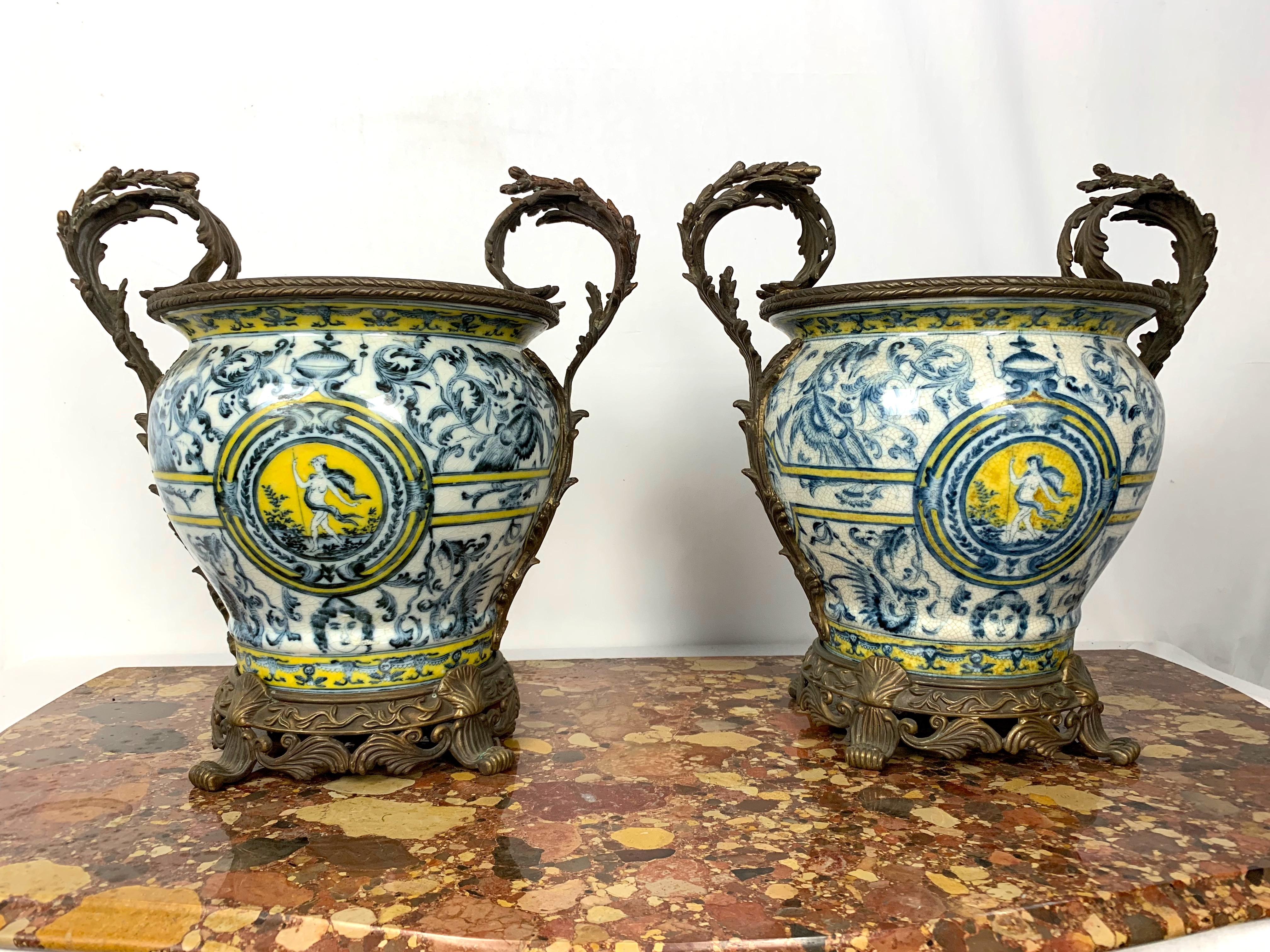 A pair of Italian Majolica Ormolu mounted urns.