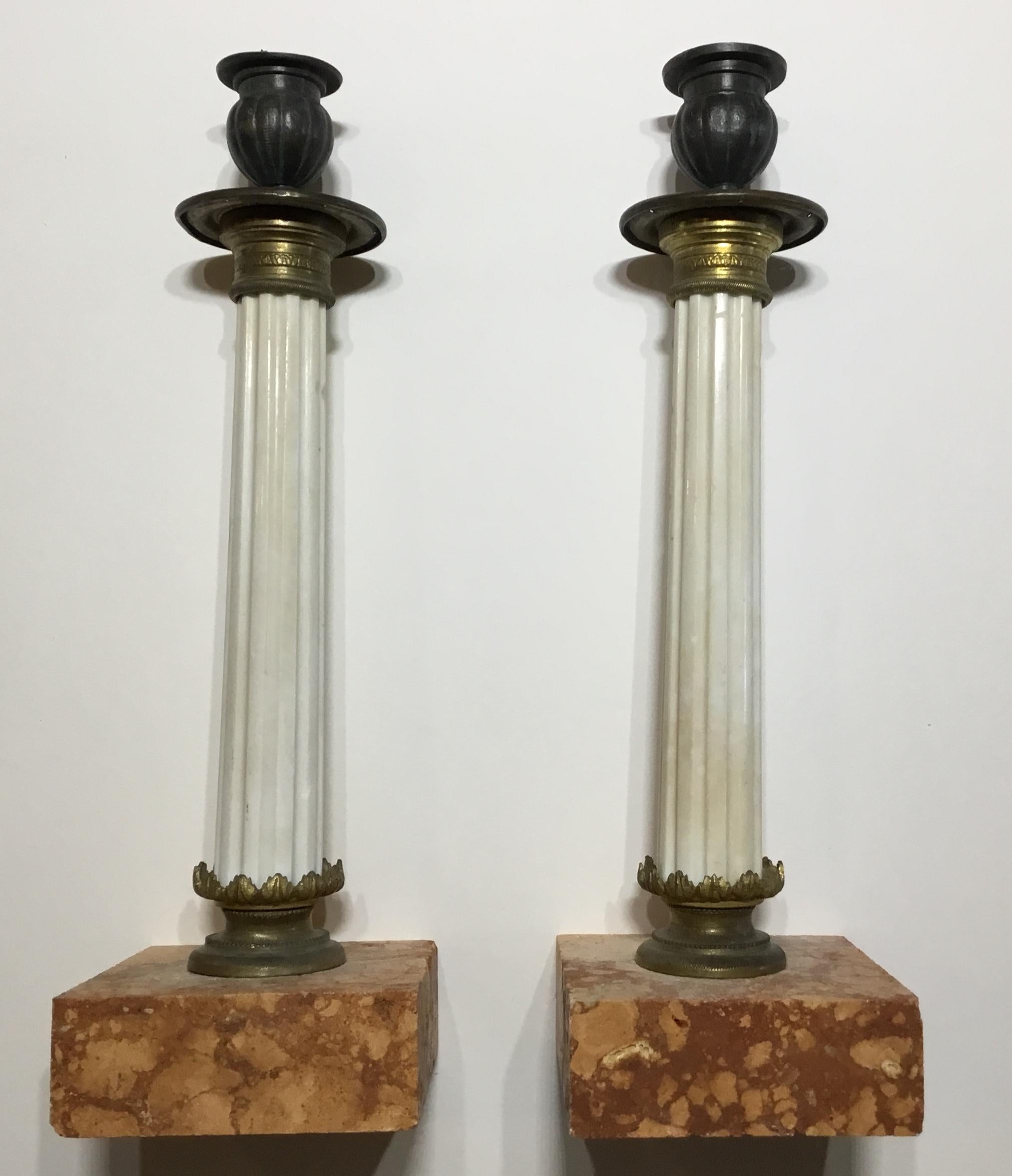Beautiful pair of candlestick made of reddish granite base, hand carved white Italian marble body, and very detailed bronze and brass hardware. The top of the candlestick is made of old lead.
Great decorative pair any room.
