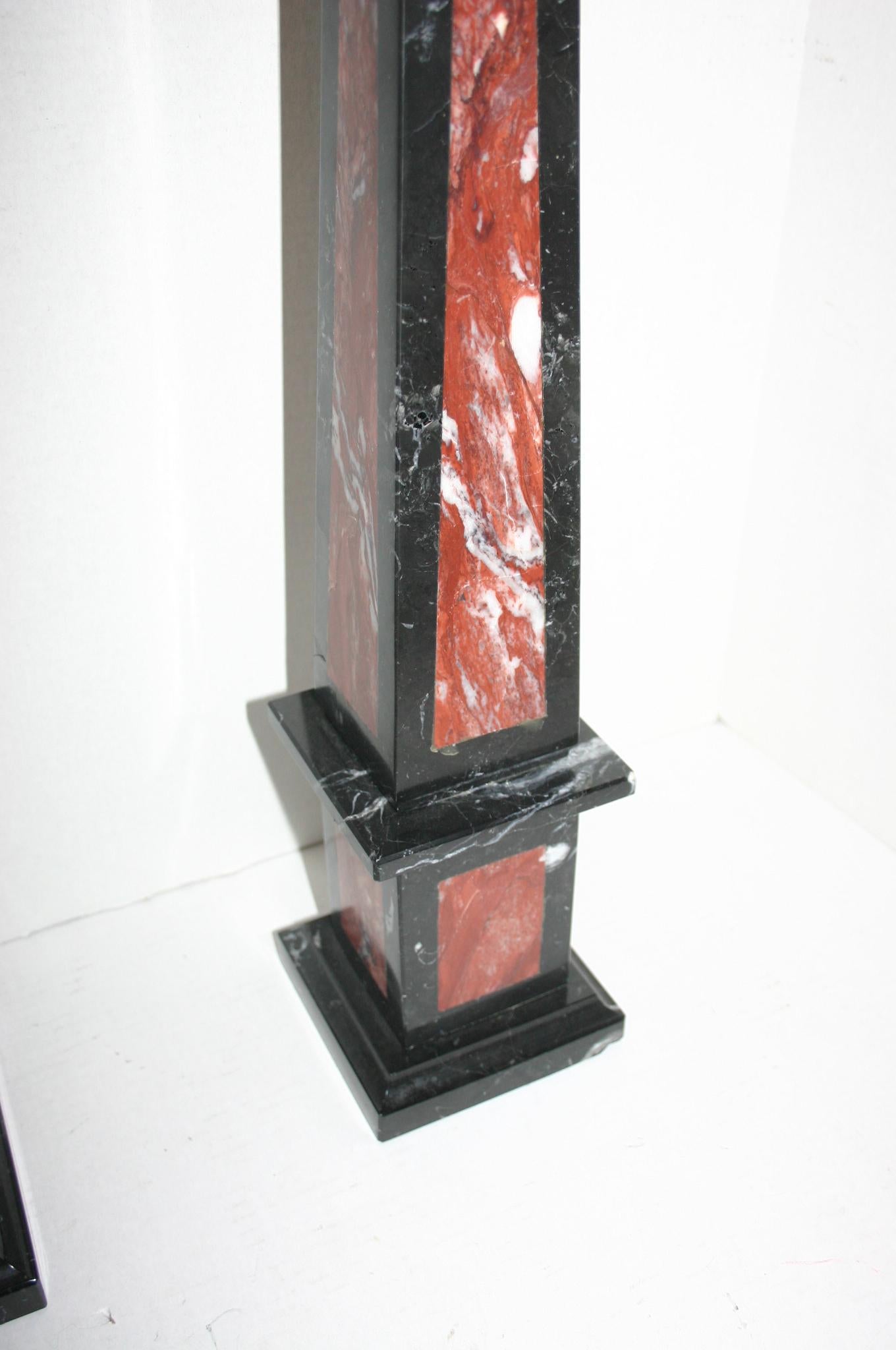Pair of circa 1940s Italian marble obelisks, with black and red marble on a pedestal base.

Measurements:
Height 25