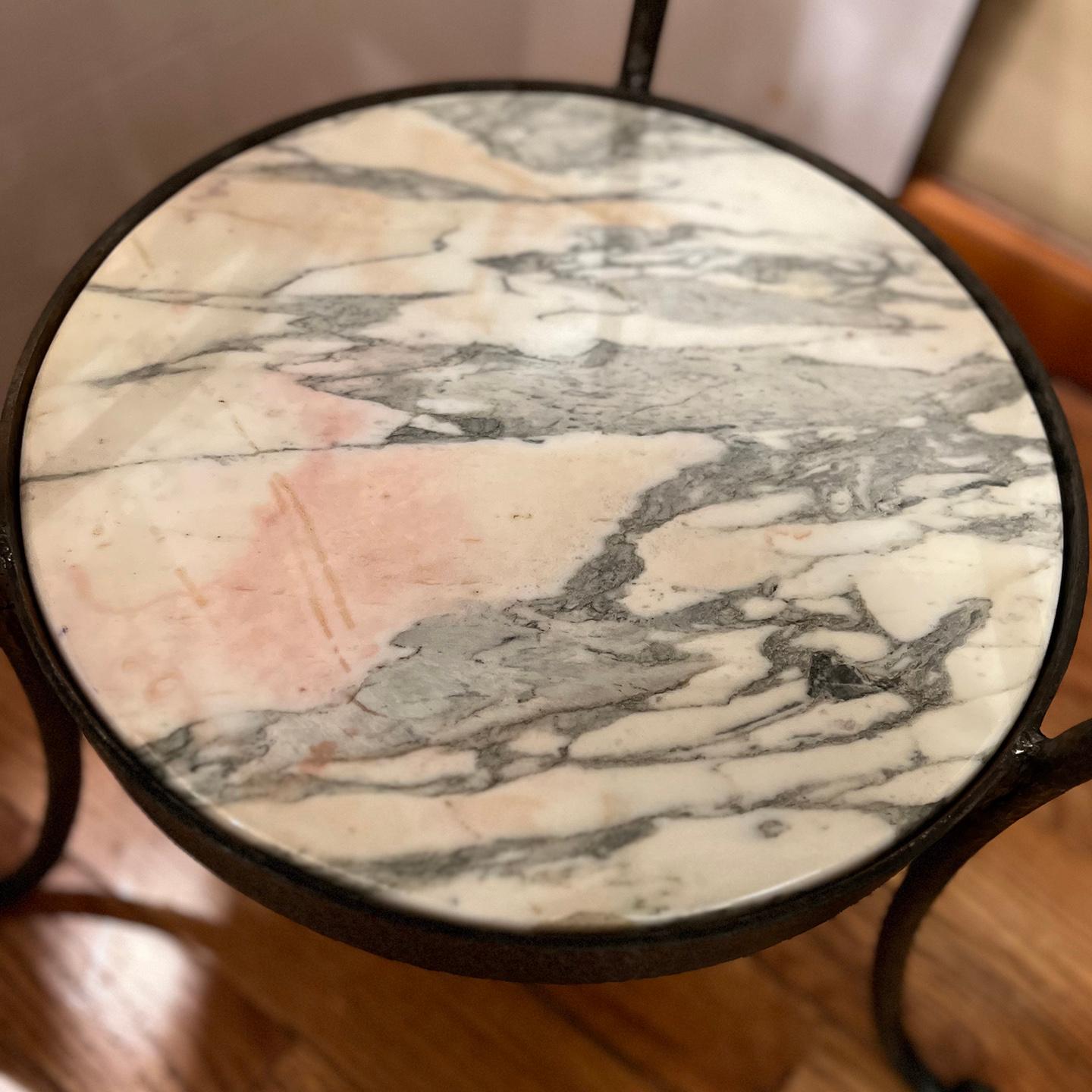 Pair of Italian 1950s hammered iron side tables with white and gray marble insets.

Measurements:
Height:25.25?
Diameter:24?.