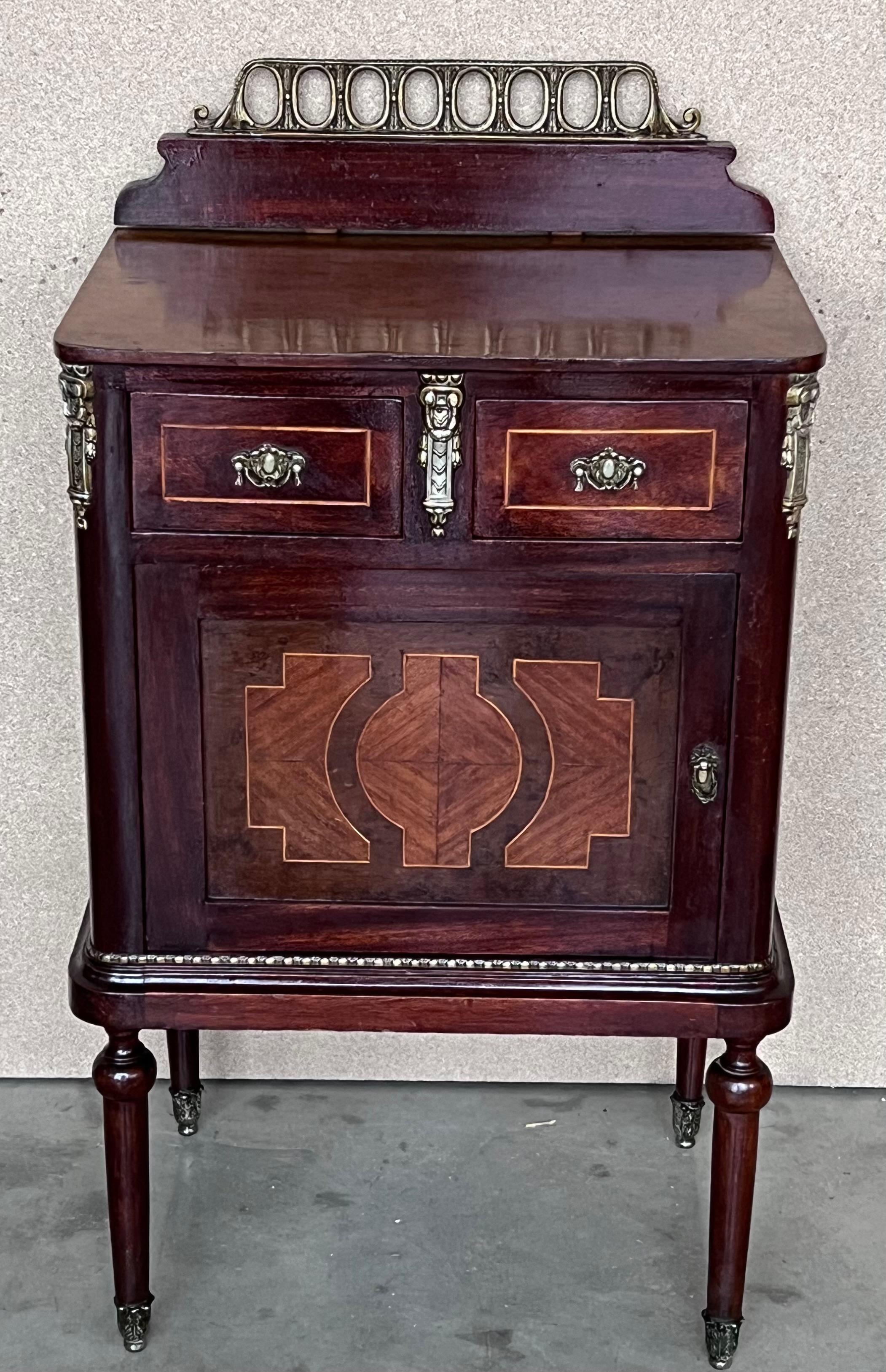 Pair of Italian Marquetry Nightstands with Bronze Crest, drawers and doors.
Little drawers in higher part and door. Both drawers and door with marquetry.
