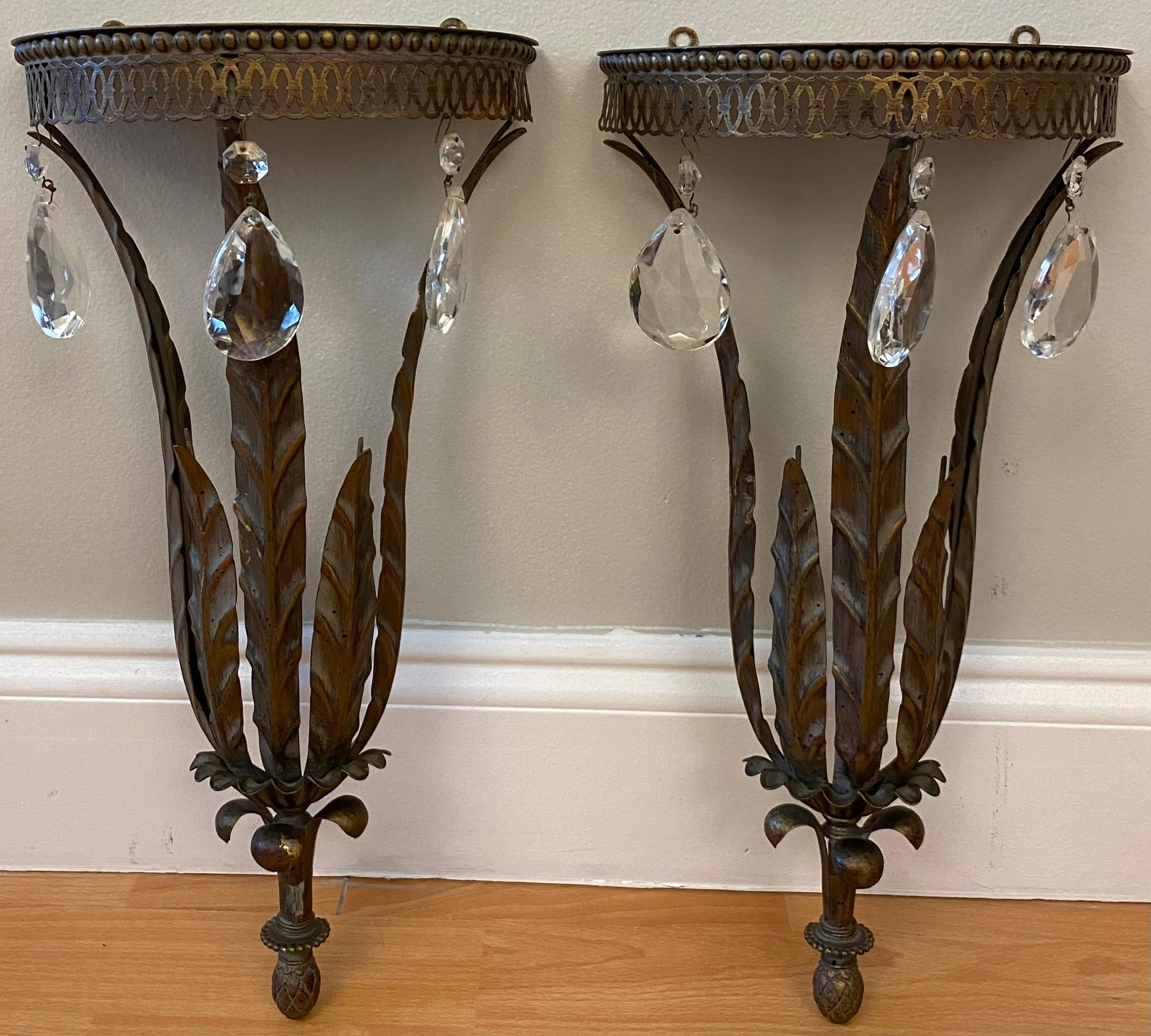 A gorgeous pair of vintage Hollywood Regency style Italian metal and crystal wall brackets shelves. These lovely shelves have beautiful droplet crystals. They are perfect for displaying decorative collectibles or are lovely on their own.

Each shelf