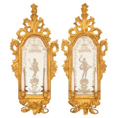 Antique pair of Italian mid 18th century Baroque Period Giltwood mirrored sconces