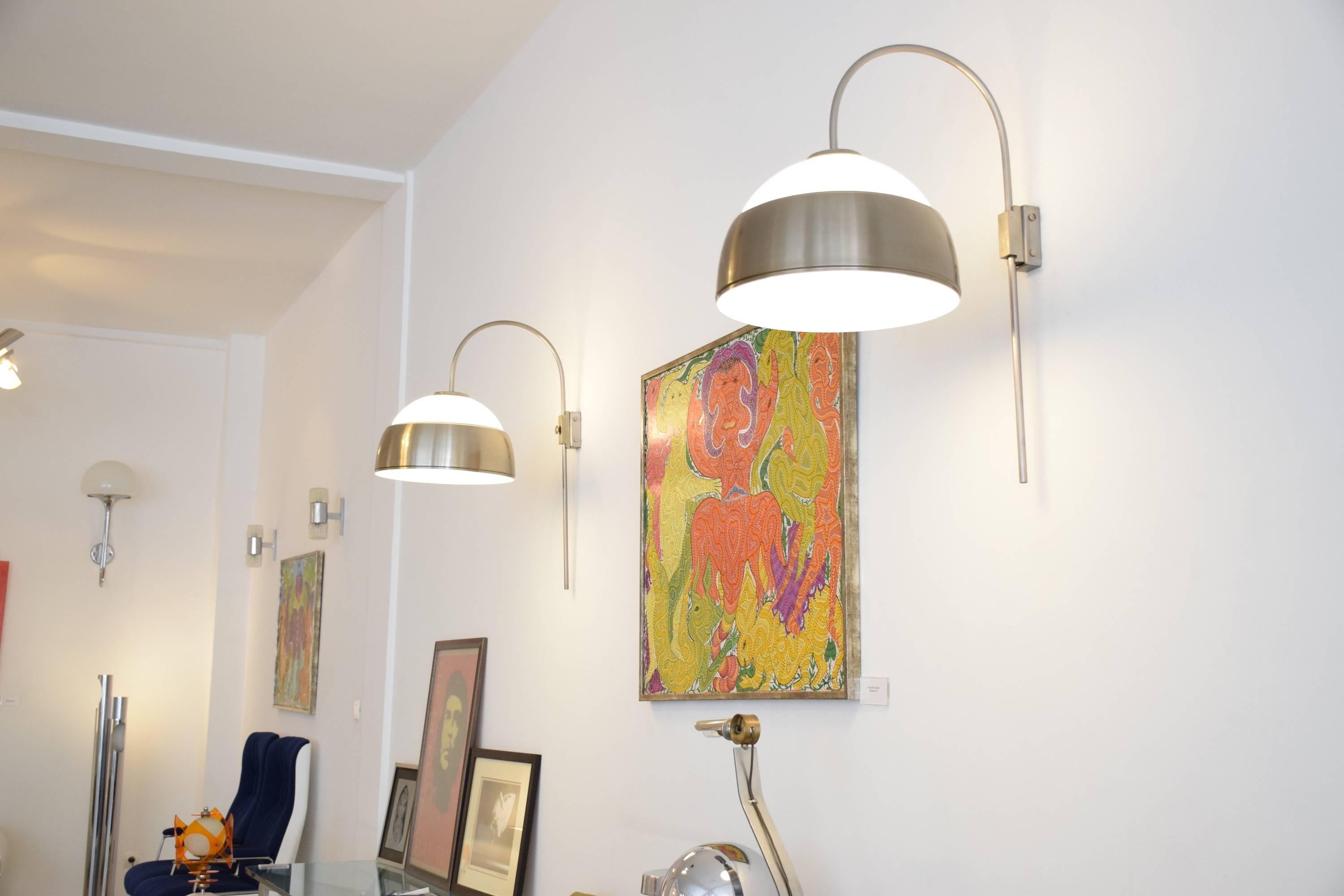 20th century vintage set of two tall and big wall lamps or sconces of Italian origin built in the 1960s. These two lights are very practical since they are adjustable in height and are composed of a polished chrome structure and impressive opal