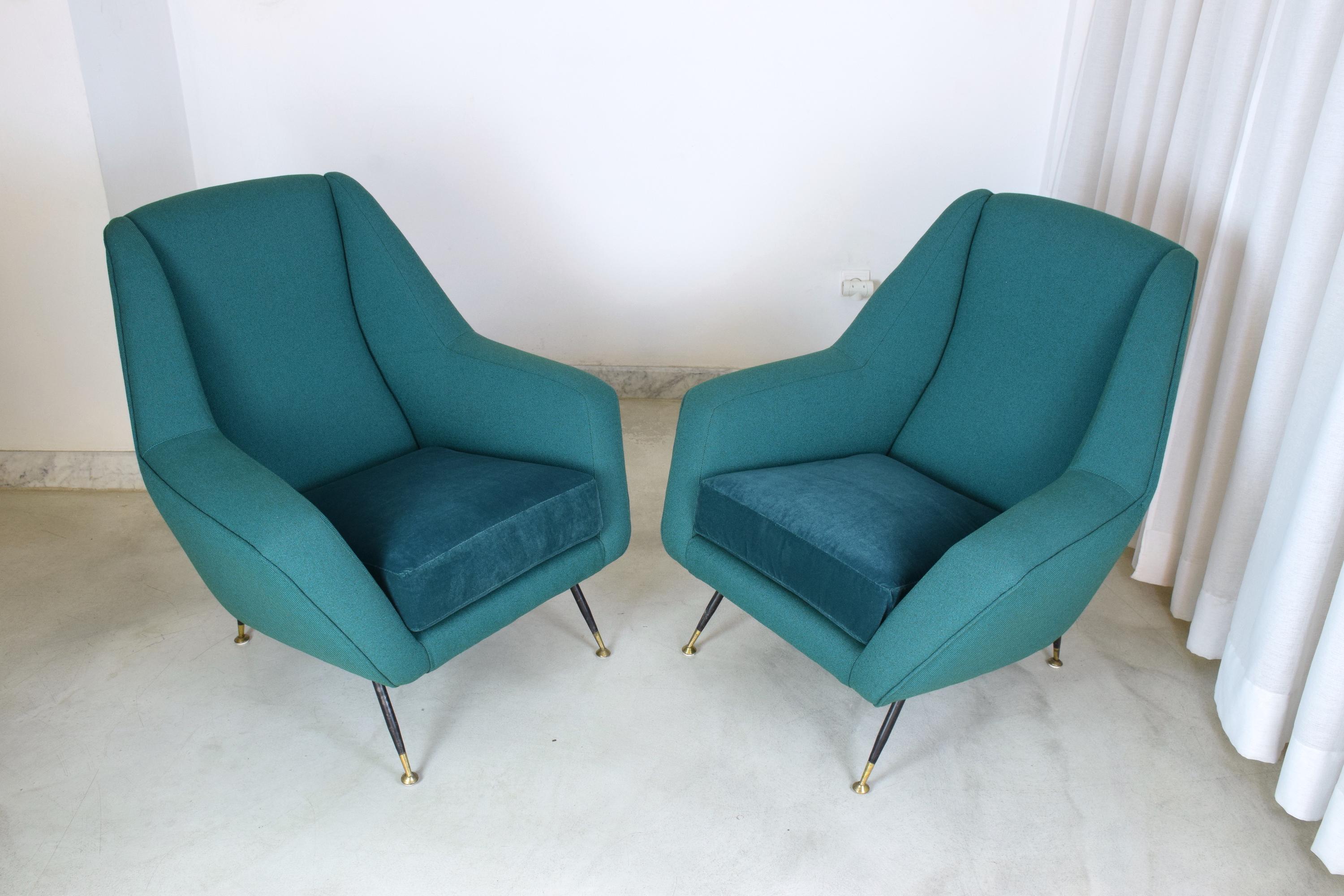 A set of two 20th century vintage lounge chairs attributed by Iconic Italian midcentury designer Gigi Radice. In fully restored condition in a blue-green upholstery with black lacquered feet and polished brass endings.

All our pieces are fully