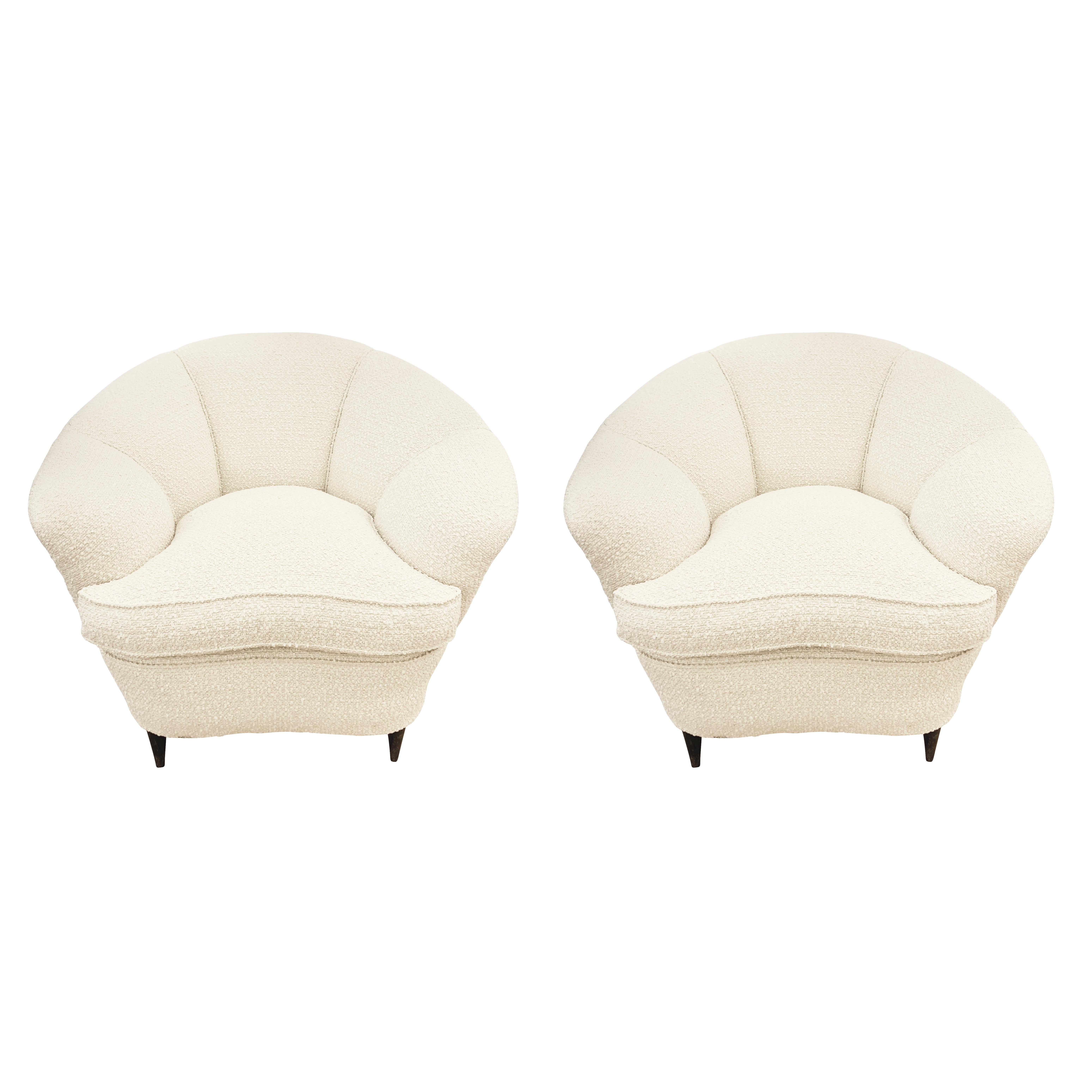 Pair of Italian Mid-Century armchairs recovered with an ivory boucle fabric and with tapering wood feet. Price for the pair-can be split on request.

Condition: Excellent vintage condition, minor wear consistent with age and use. Recently