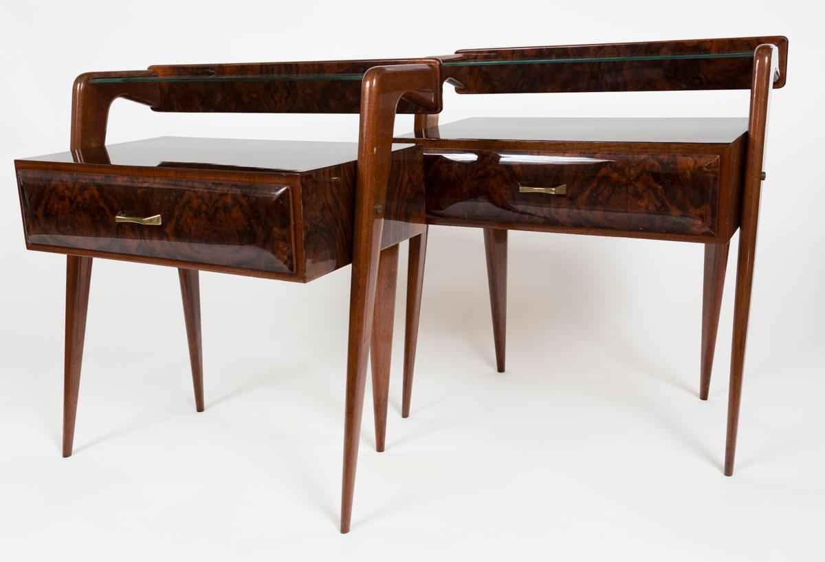 Sleek angles compose these Mid-Century Modern two-tier bedside tables with floating glass shelf and drawer below. Made from makassar veneer wood in two different cuts, these tables have been expertly restored and finish repolished.  Produced likely