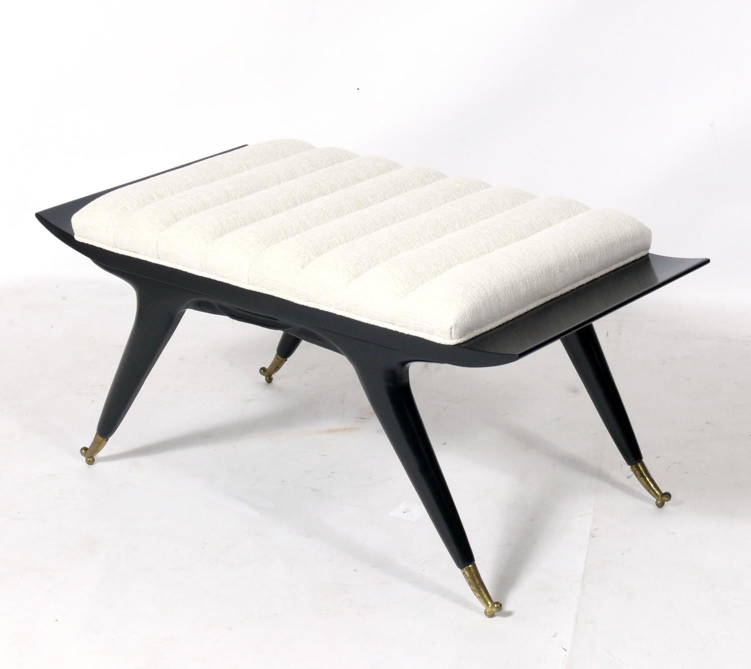 Pair of Italian mid century benches or stools, Italy, circa 1950s. They have recently been refinished in black lacquer and plush ivory color channeled upholstery. Brass sabots retain warm original patina.