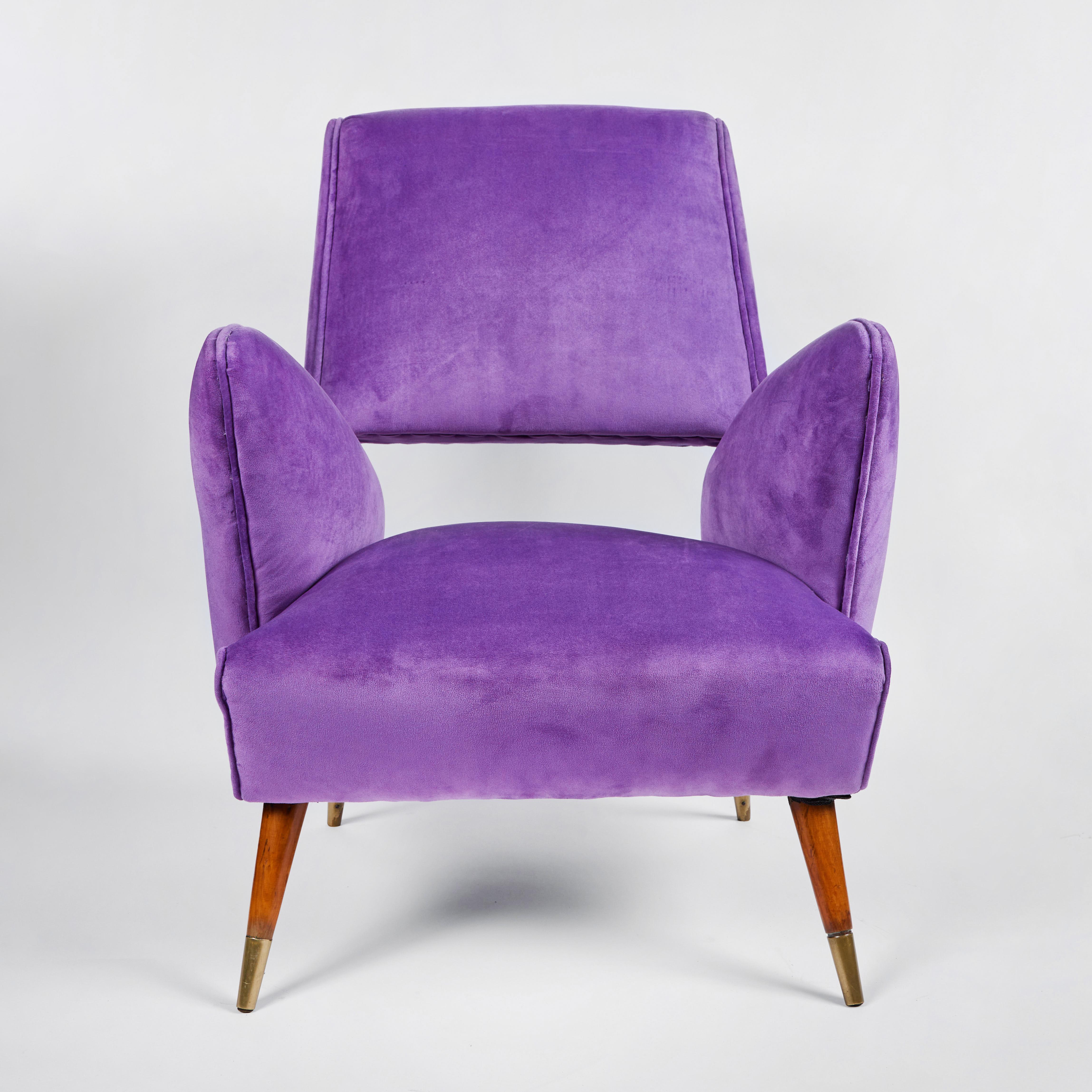 Chic pair of sculptural Italian mid-century chairs by Nino Zoncada, circa 1950's. Chairs have walnut legs with brass sabots.  Upholstered  in a purple microfiber fabric.