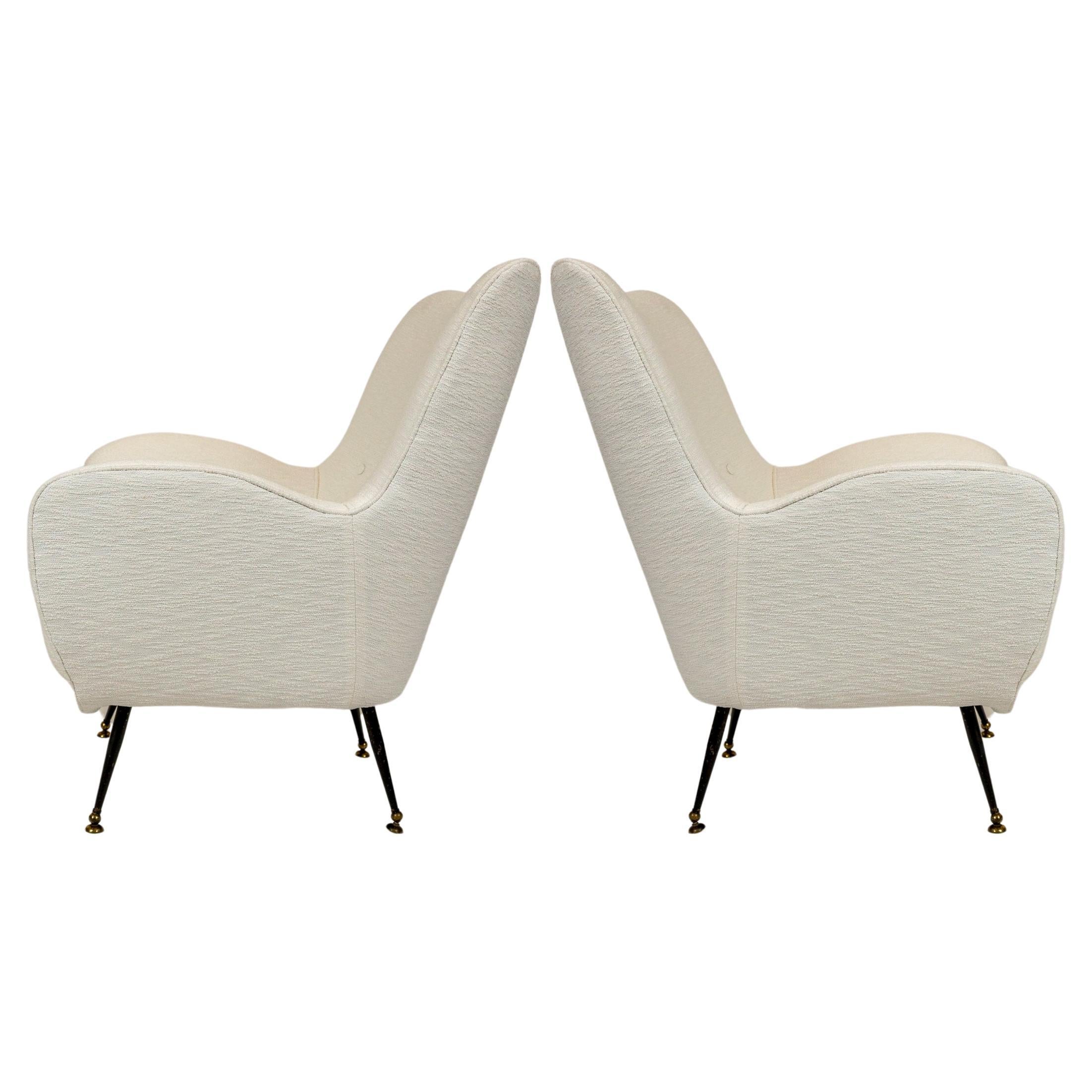 A period mid century pair of newly upholstered chairs with their original painted steel and brass legs.  The brass feet rotate to adapt to uneven flooring a detail seen in orginal mid century chairs.

The curving lines of these chairs are unique and