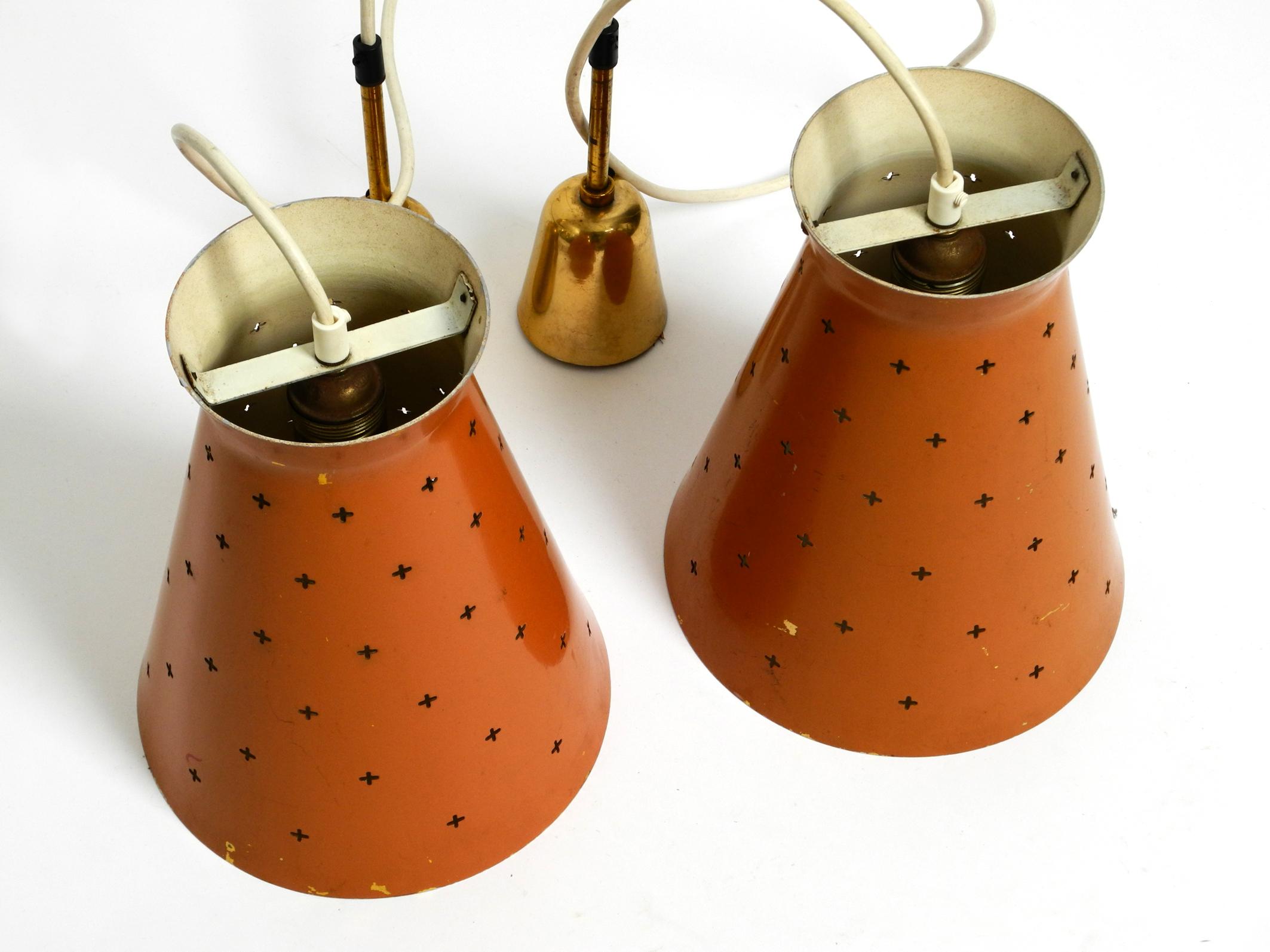 Mid-Century Modern Pair of Italian Mid Century Diabolo design perforated sheet metal pendant lamps For Sale