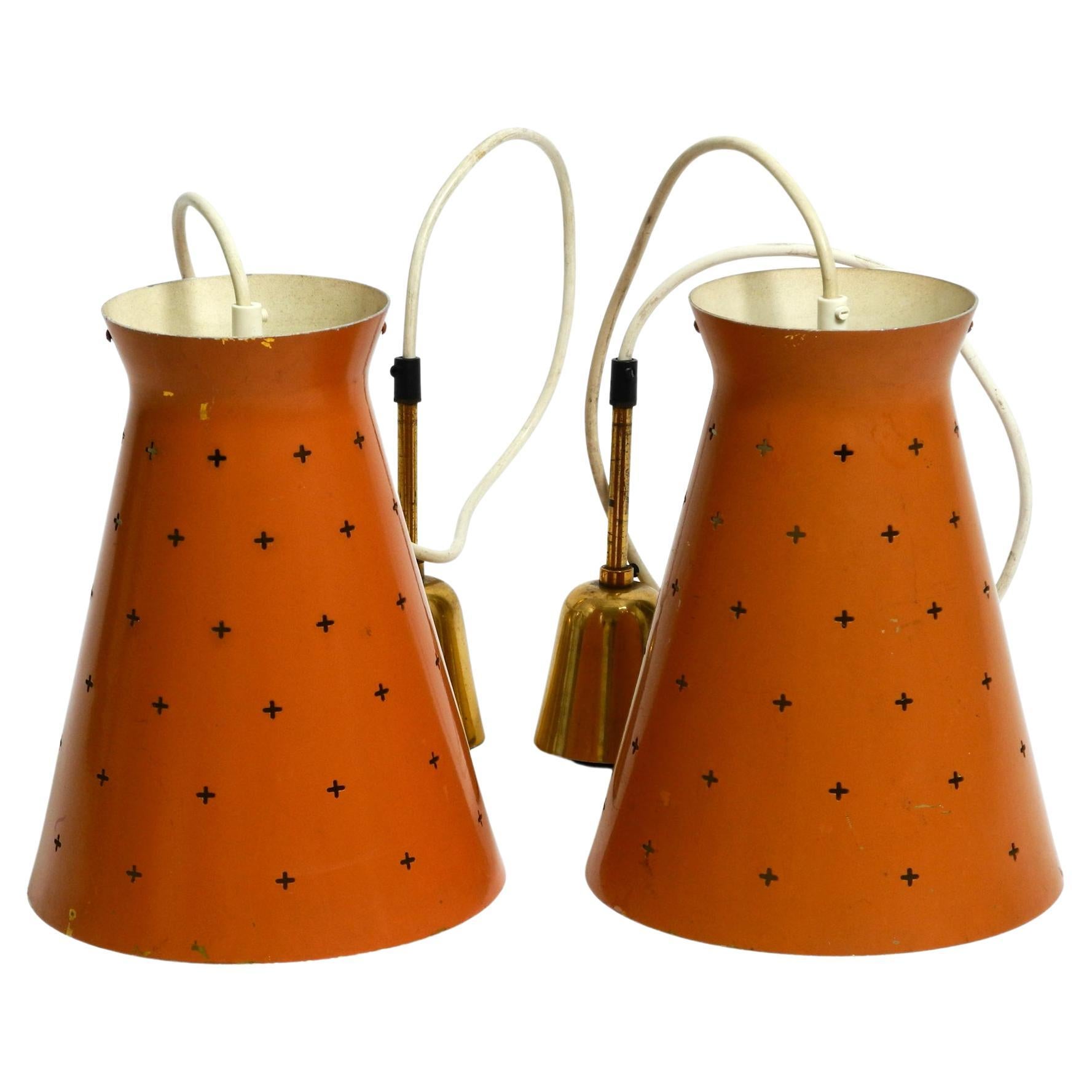 Pair of Italian Mid Century Diabolo design perforated sheet metal pendant lamps For Sale