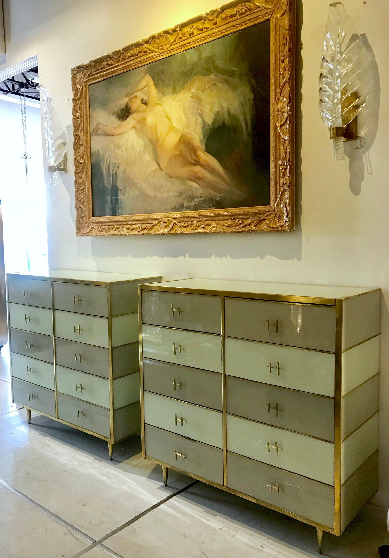 Beautiful pair of Italian taupe and ivory glass chests with tapered brass legs, trim and hardware.                 

